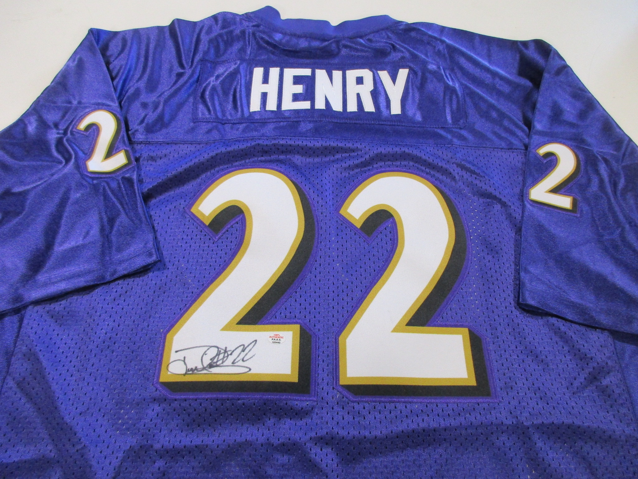 Purple football jersey with HENRY nameplate, number 22, and a signature visible above the numerals