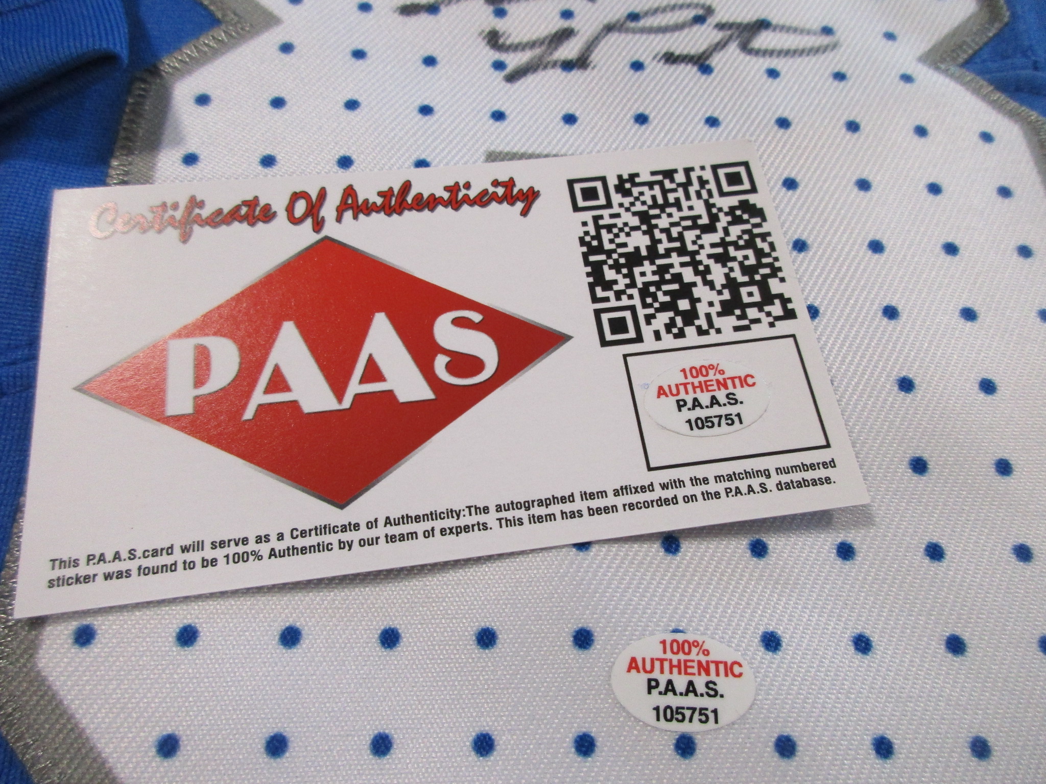 P.A.A.S. Certificate of Authenticity card with QR code and matching numbered sticker resting on the jersey's number panel