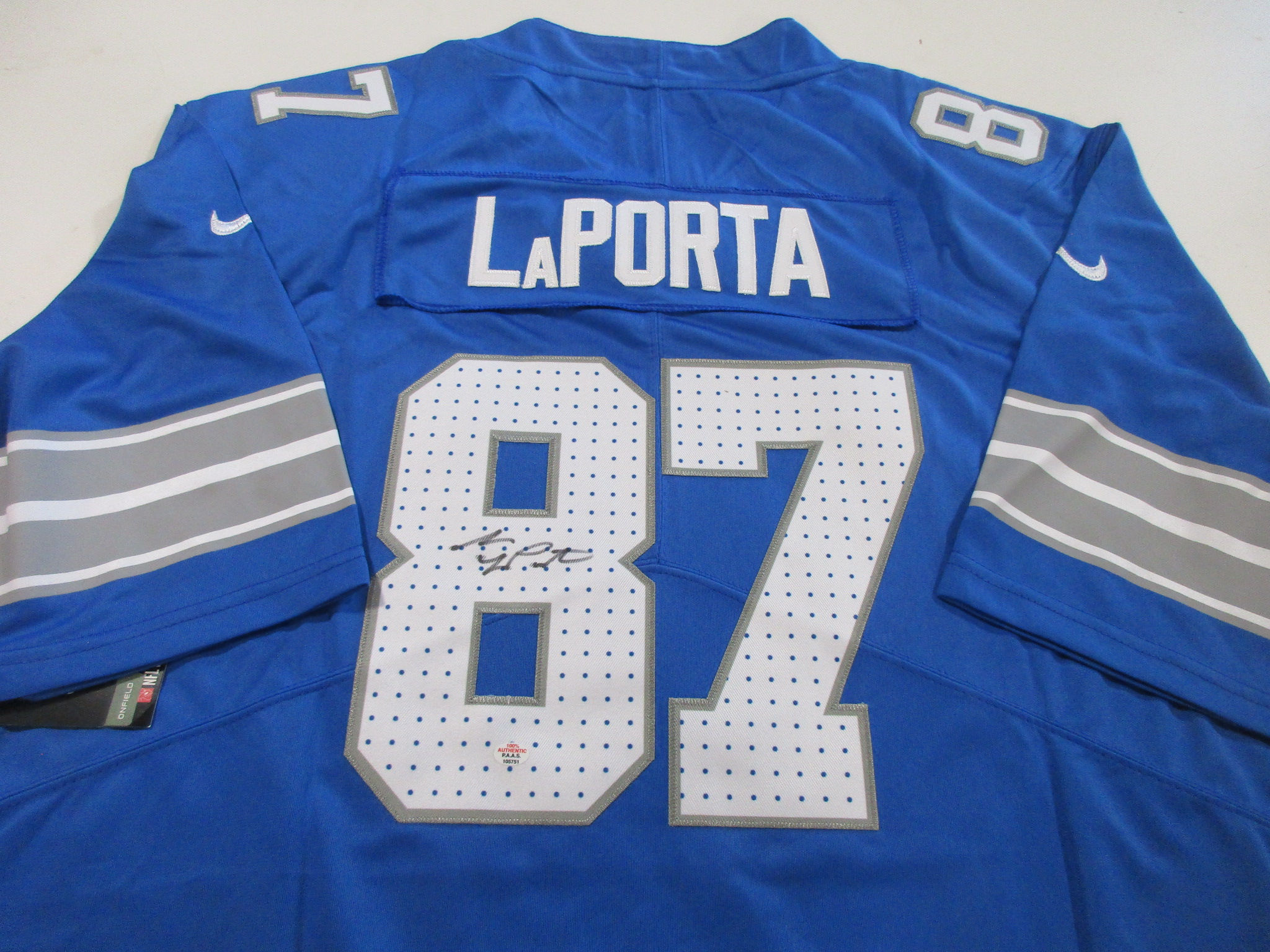 Back view of blue Detroit Lions jersey with LaPORTA nameplate, number 87, and a signature visible on the lower number