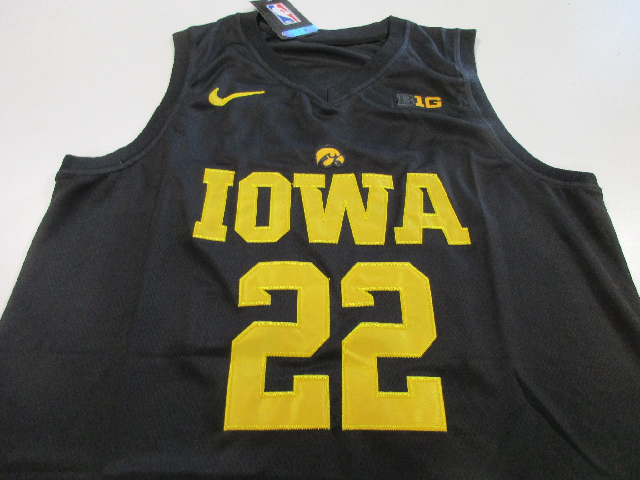 Front view of black Iowa Hawkeyes jersey showing Nike swoosh, Big Ten B1G patch, Hawkeye logo, and number 22