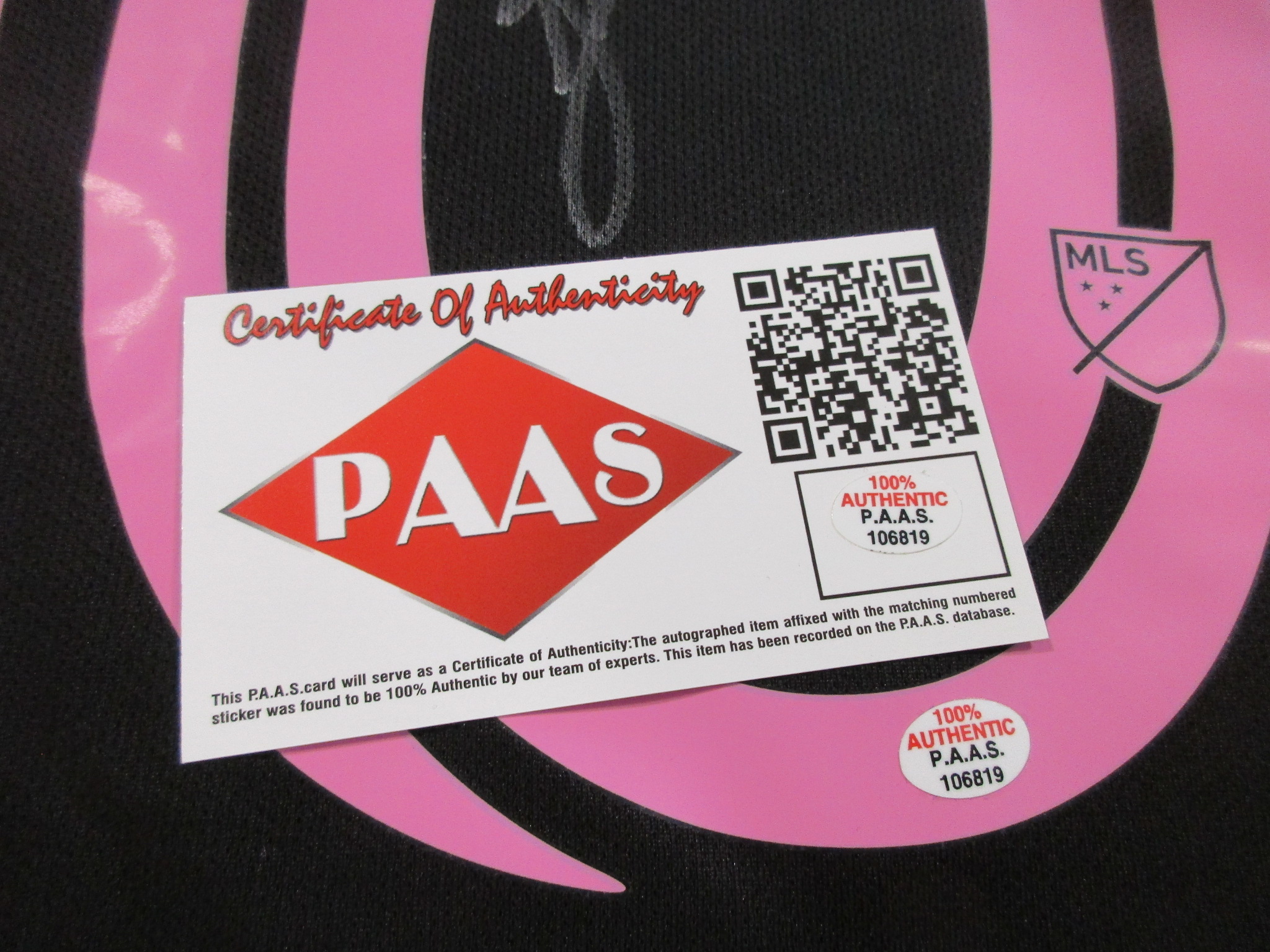 Close-up of P.A.A.S. certificate of authenticity sticker with QR code affixed to the jersey