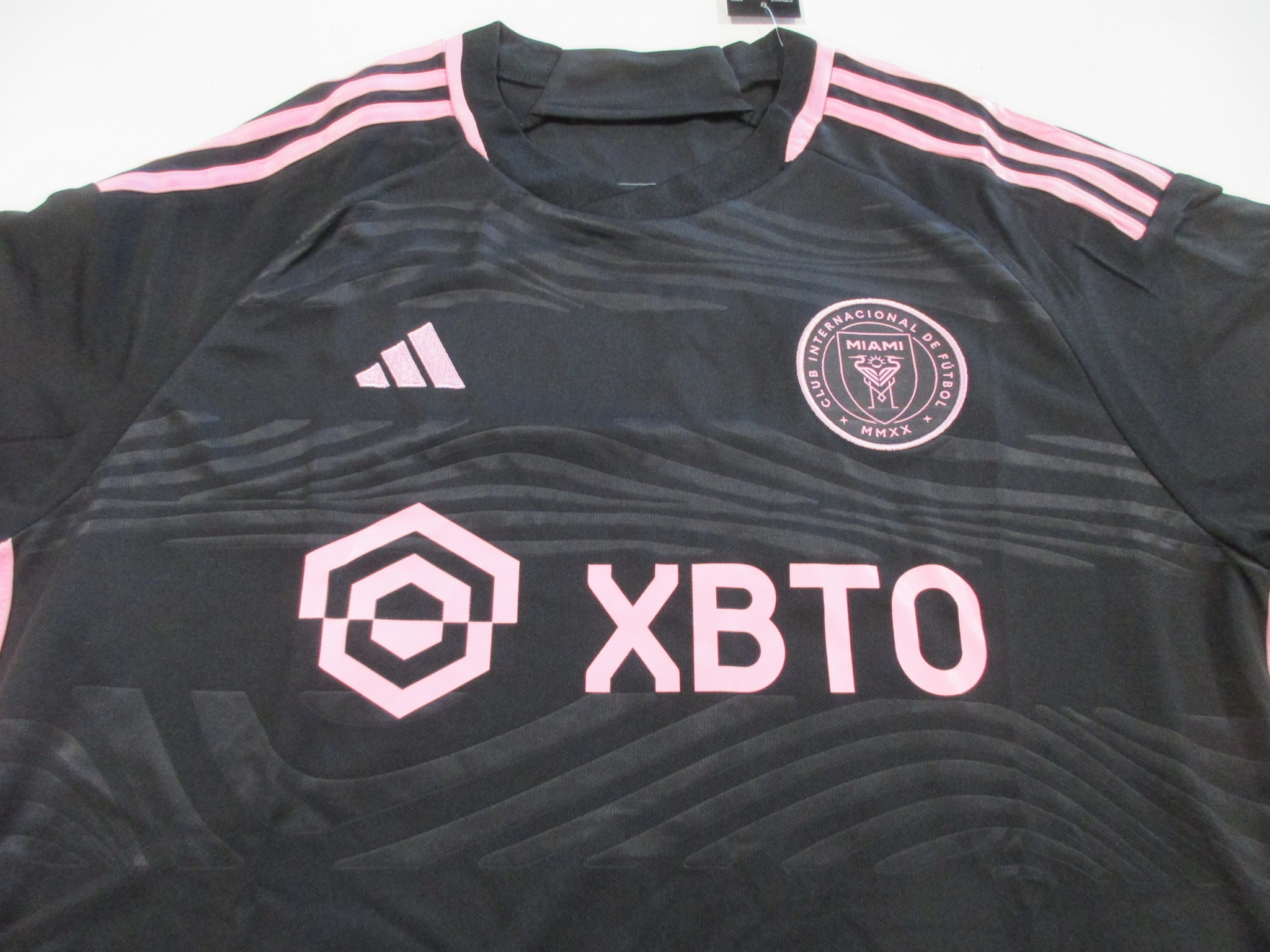 Front of black Inter Miami CF jersey showing Adidas logo, club crest, and XBTO sponsor text