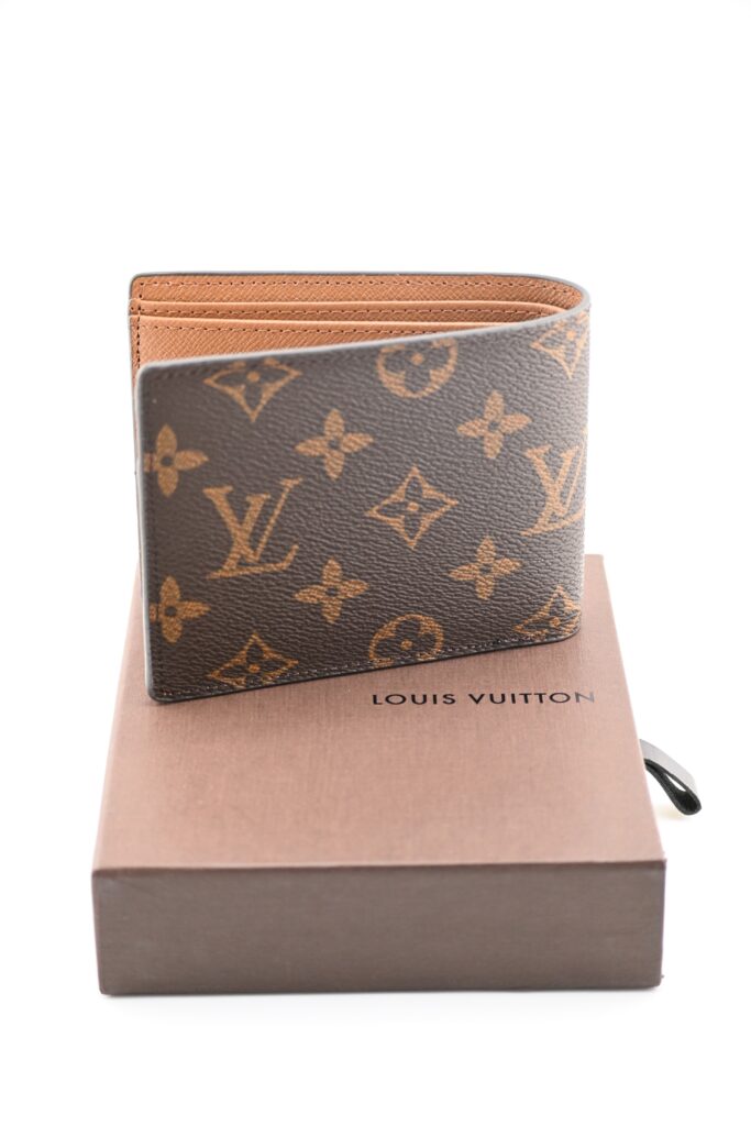 Louis Vuitton Monogram canvas bifold wallet standing upright on its original brown box