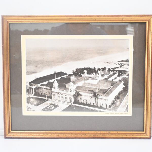 Gold-framed sepia aerial photograph of a large seaside building complex captioned Henry Morrison Flagler Museum