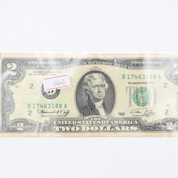 Front of the two-dollar note in a protective plastic sleeve with a small inventory tag reading 0046