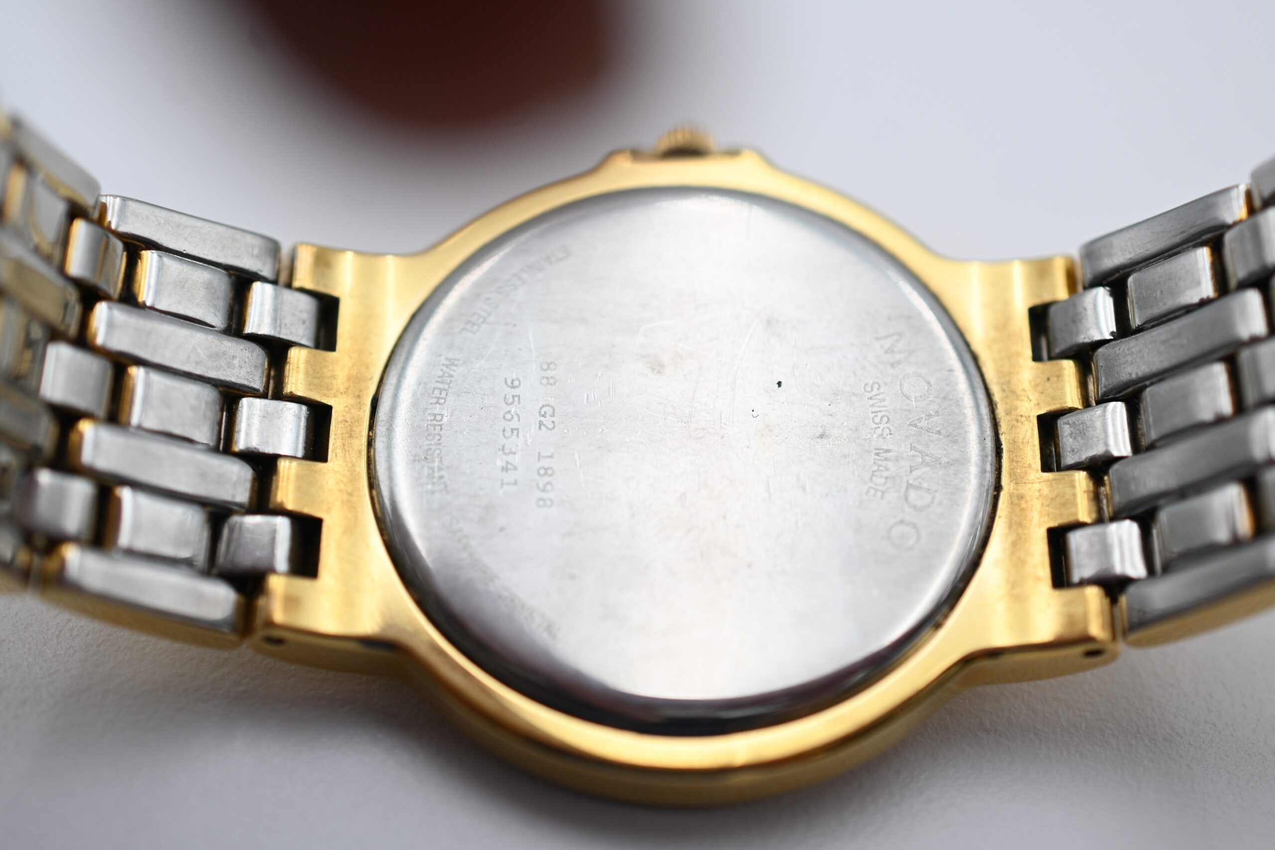 Close-up of the engraved case back reading MOVADO SWISS MADE with reference and serial numbers