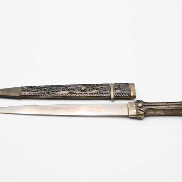 Dagger drawn from its scabbard, showing the blade, wire-wrapped hilt, and matching decorated scabbard side by side
