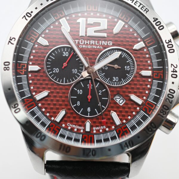 Close-up of Stührling Original chronograph watch face with red dial and tachymeter bezel
