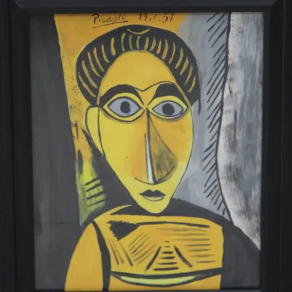 Framed cubist-style portrait painting in yellow, black, and grey with a signature and date inscribed in the upper left corner