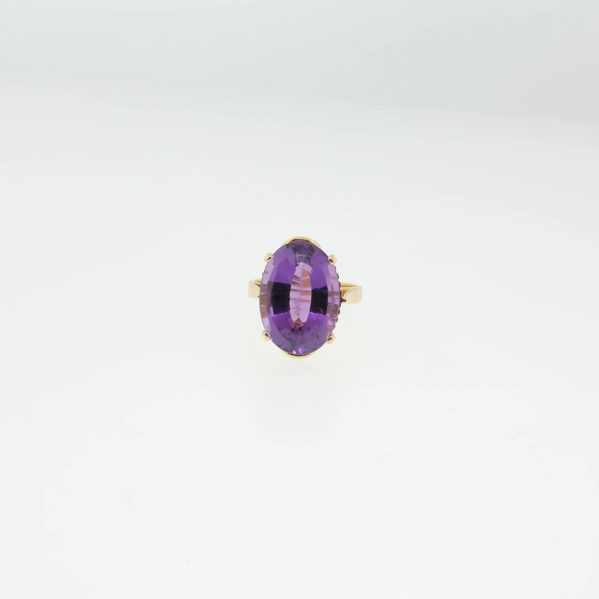 Top-down view of ring showing full face of the oval purple stone