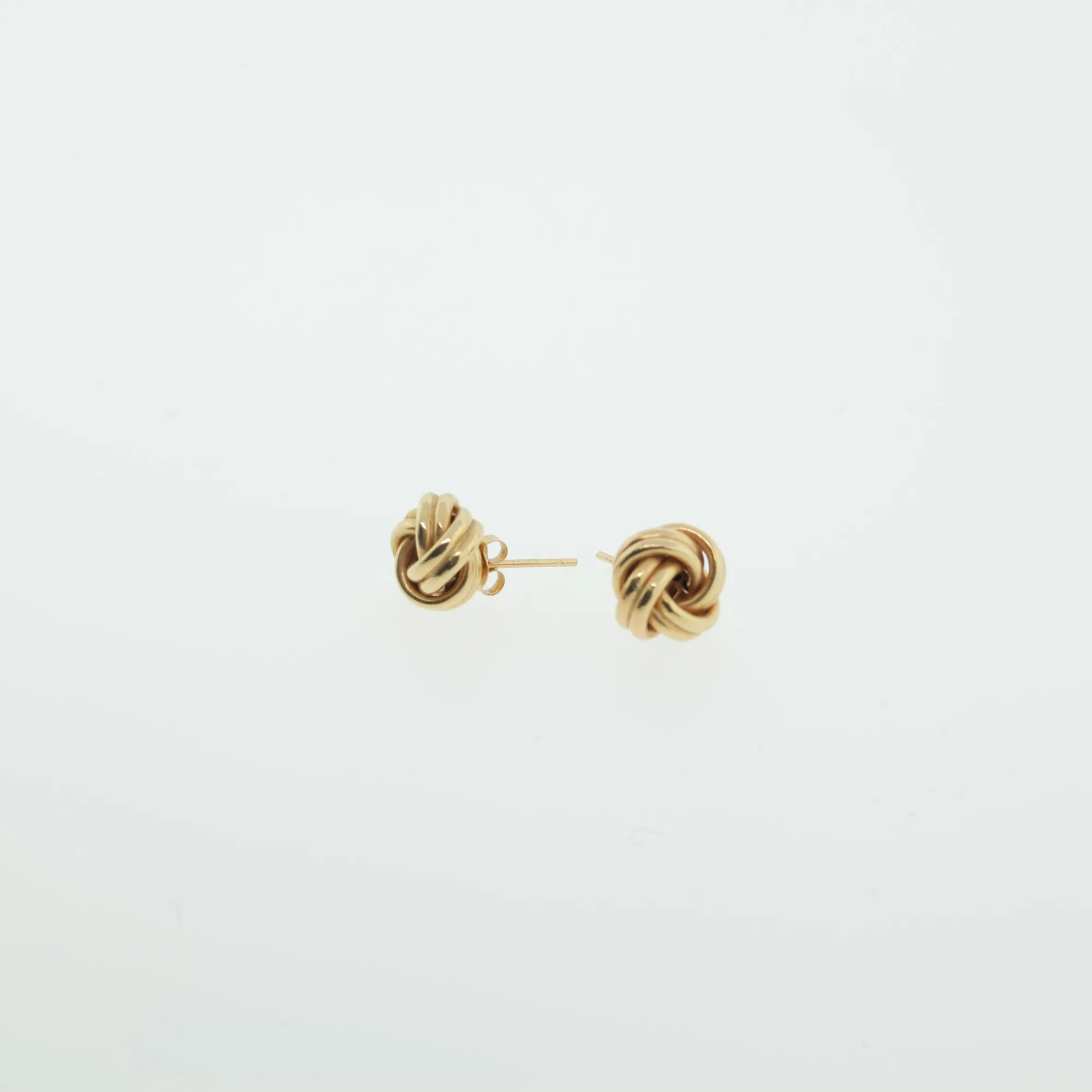 Pair of gold-tone love-knot stud earrings shown from the side against a white background