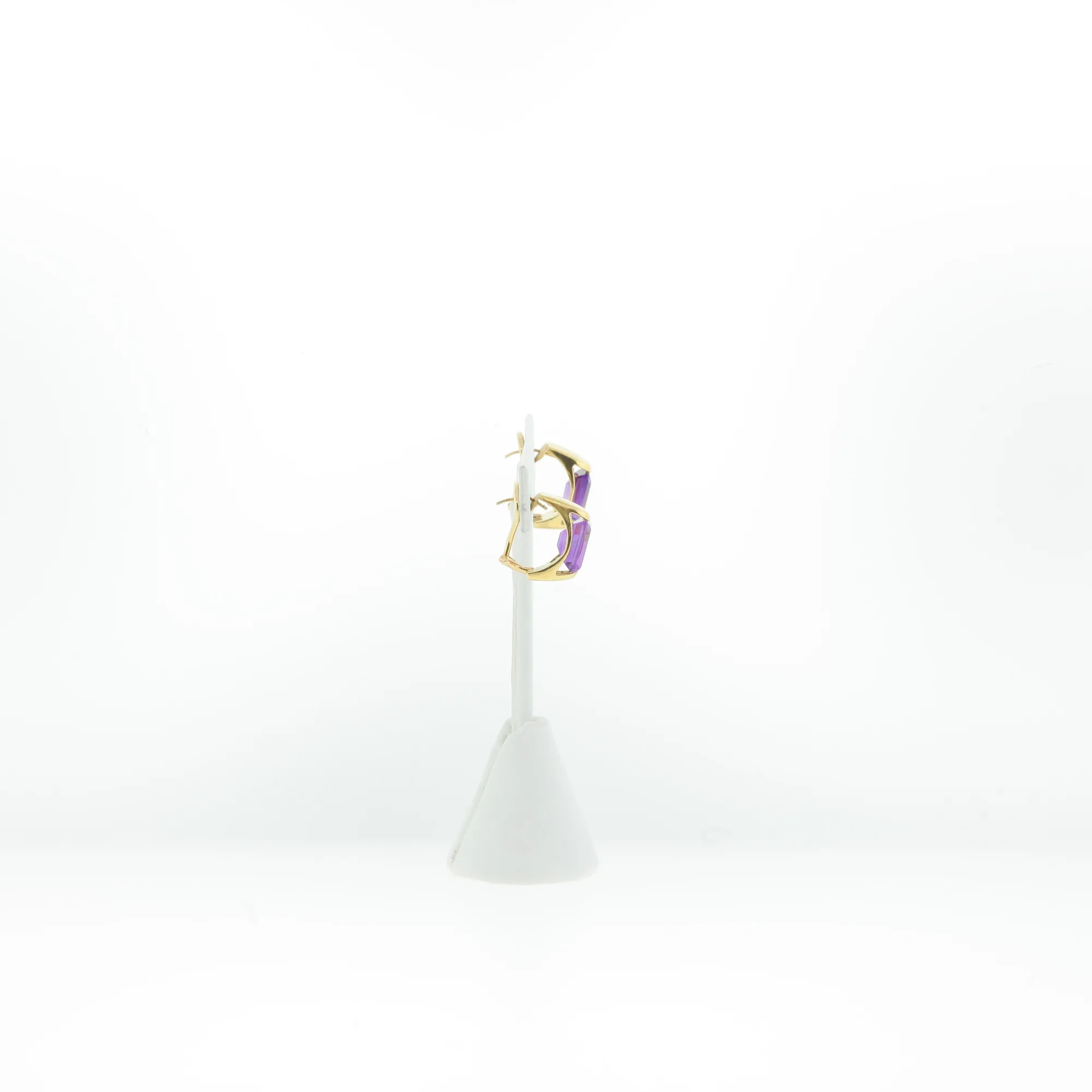 Side profile of gold-tone earrings with purple stones mounted on a display stand post