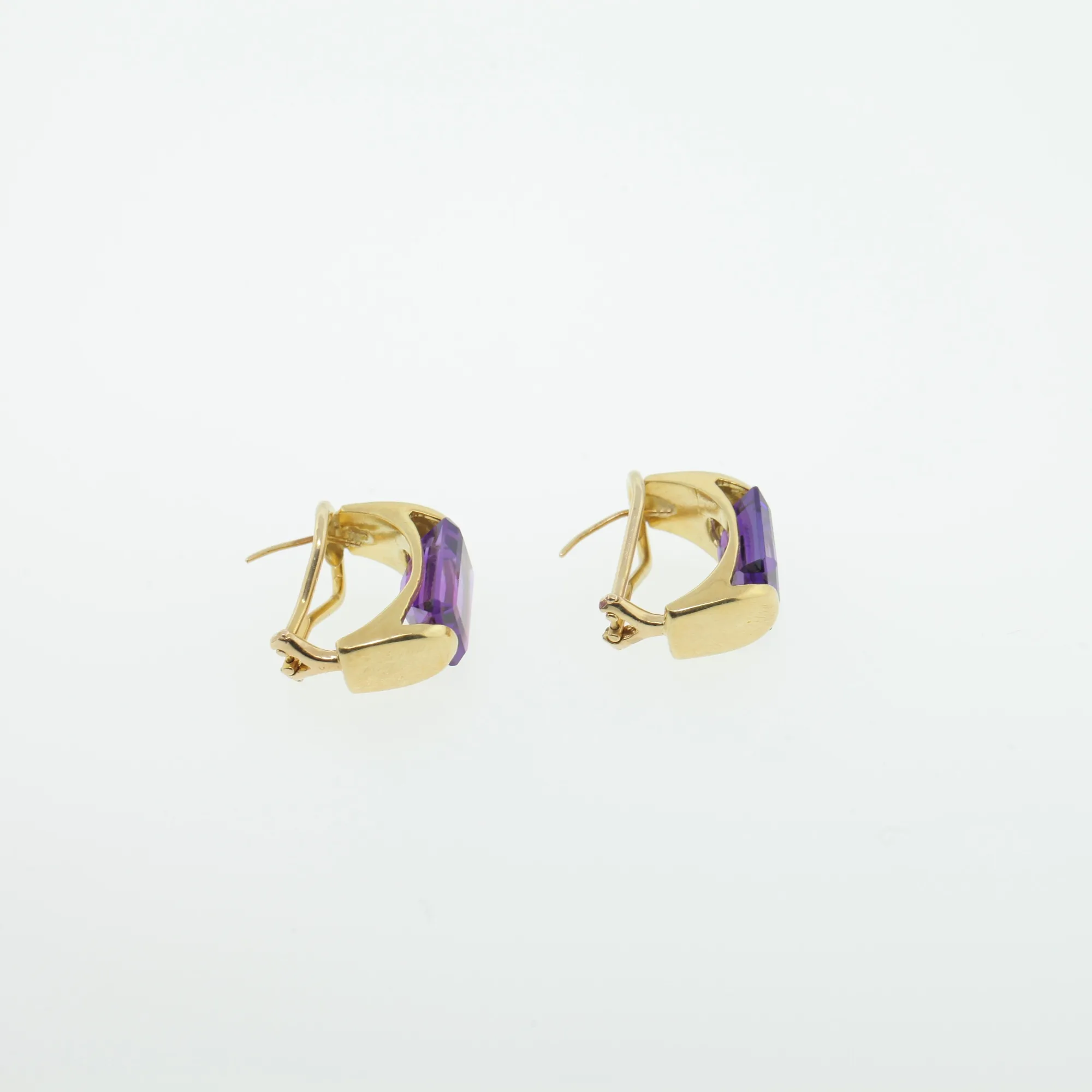 Reverse angled view of gold-tone earrings showing the hinge, clip, and post hardware
