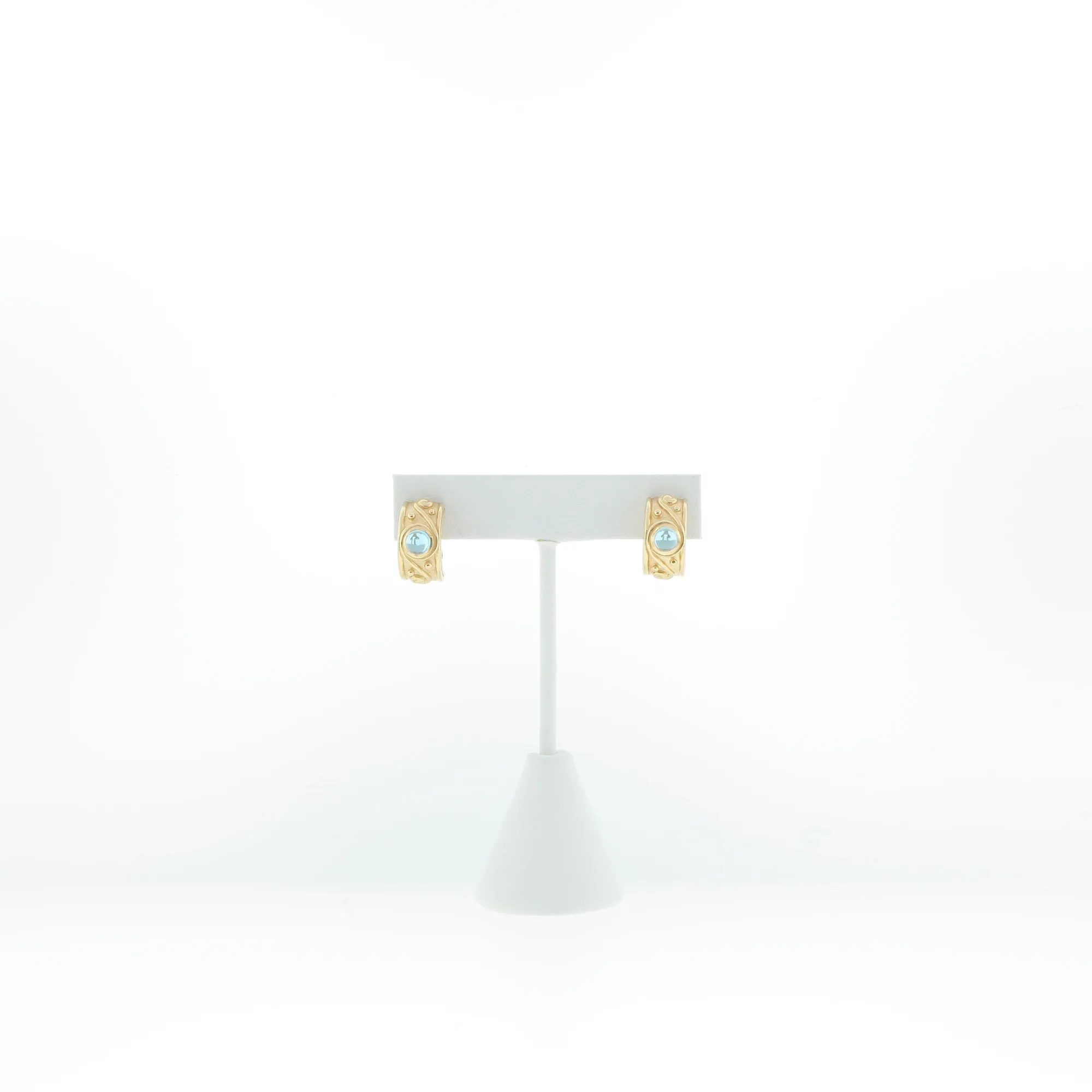 Front view of the earring pair mounted on a white display card and stand