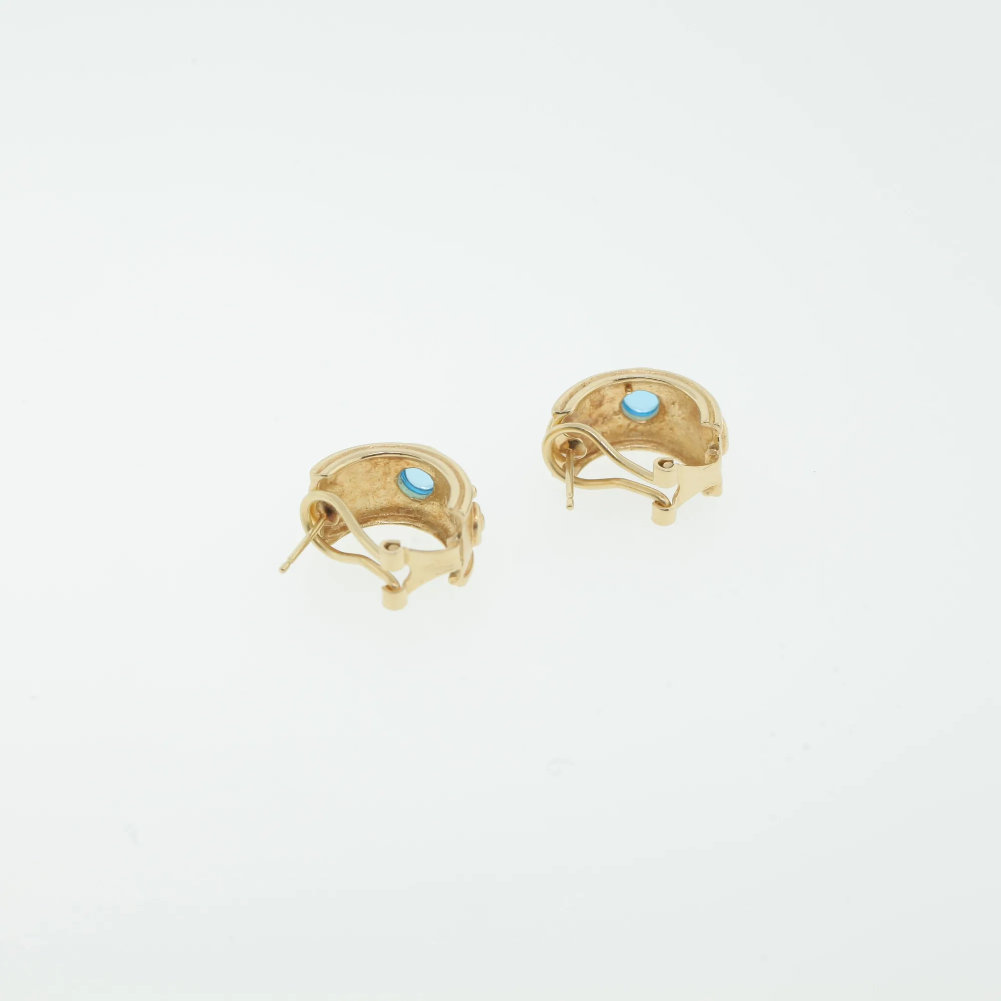 Interior view of the earring backs showing omega clips and stone bezels from behind