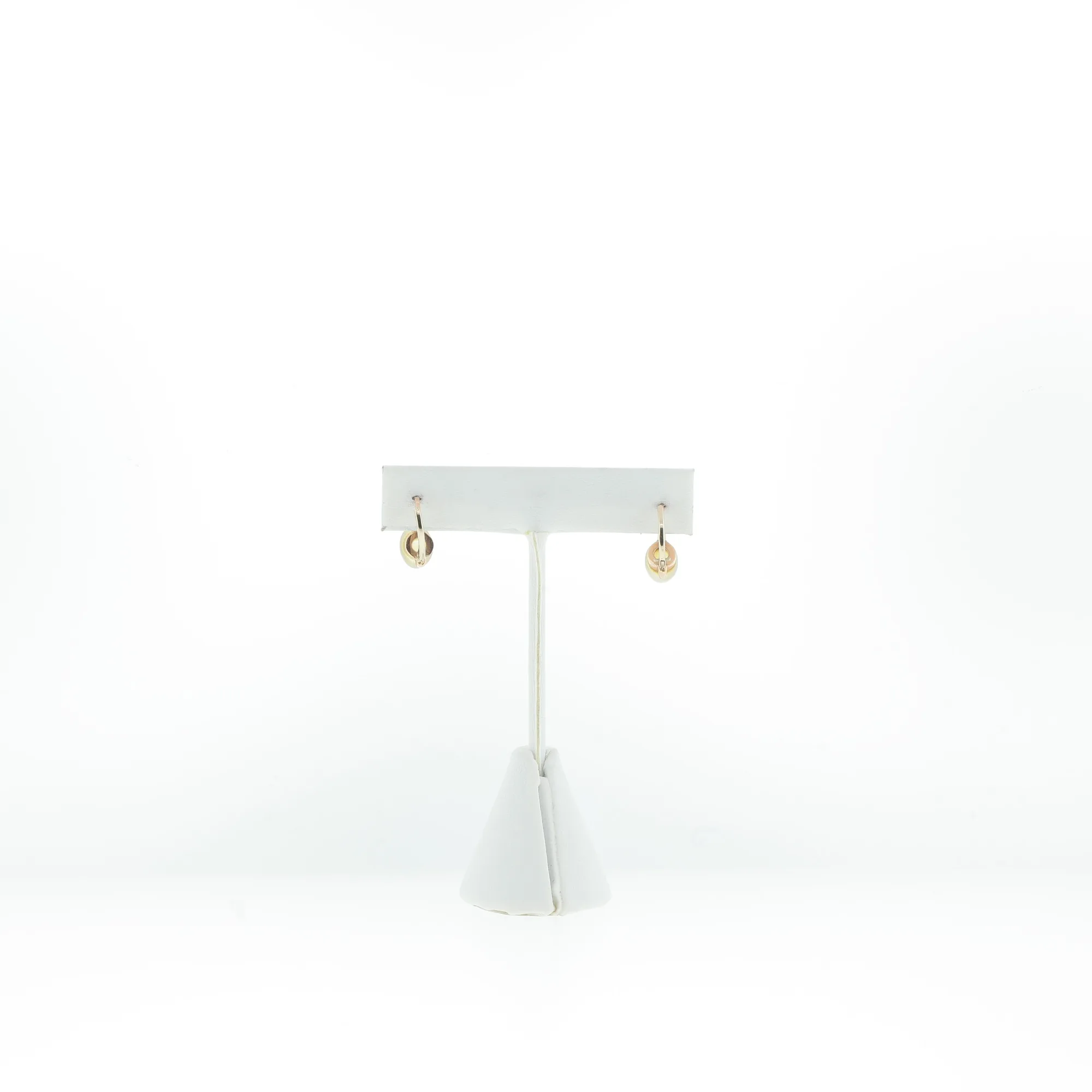 Pair of hoop earrings displayed hanging on a white T-bar jewelry stand, front view
