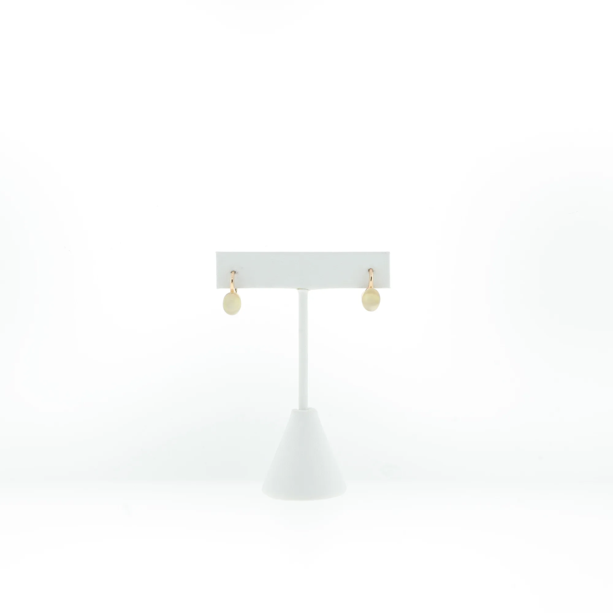 Front view of earrings on stand highlighting the plain cabochon stone facing outward