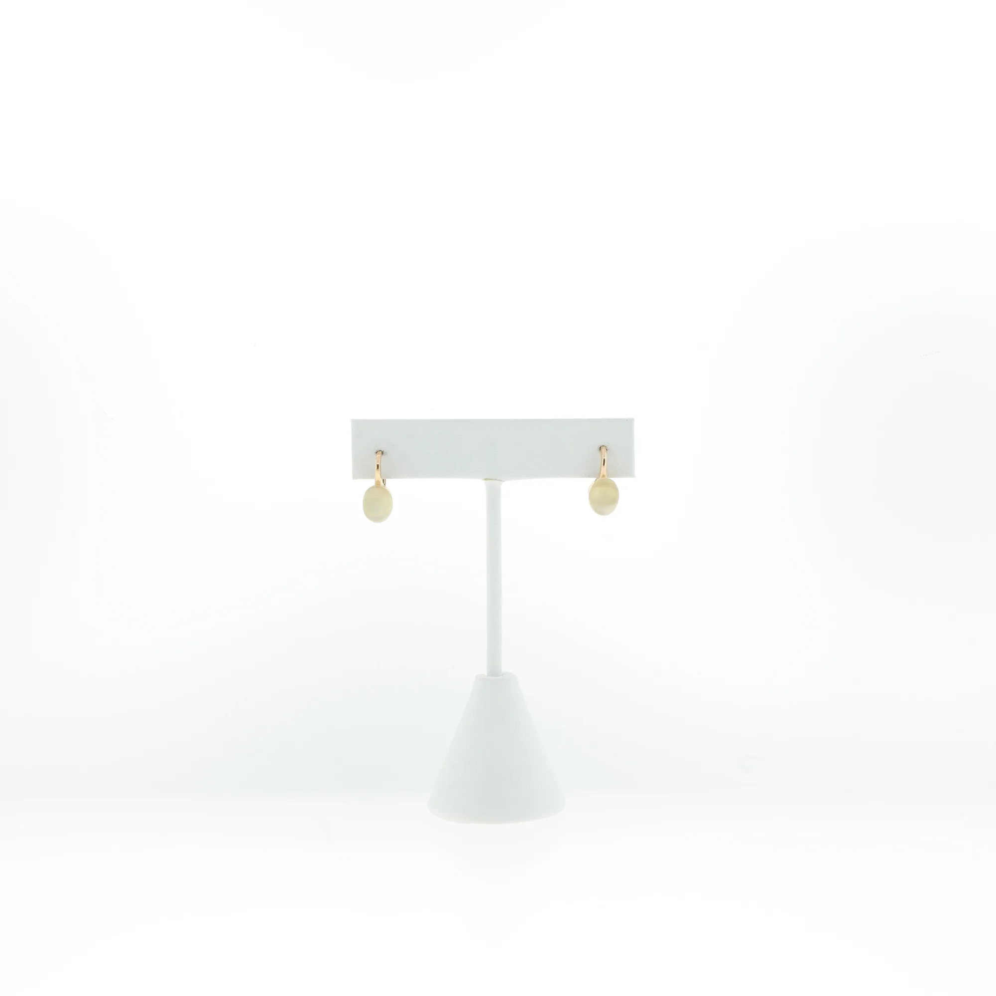 Front-facing view of earrings on display stand against white backdrop
