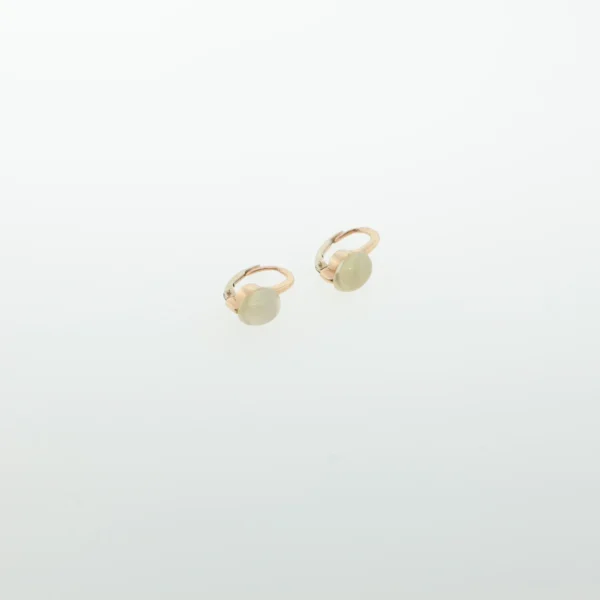 Close-up of rose gold-tone hoop earrings with pale oval cabochon stones on a white background