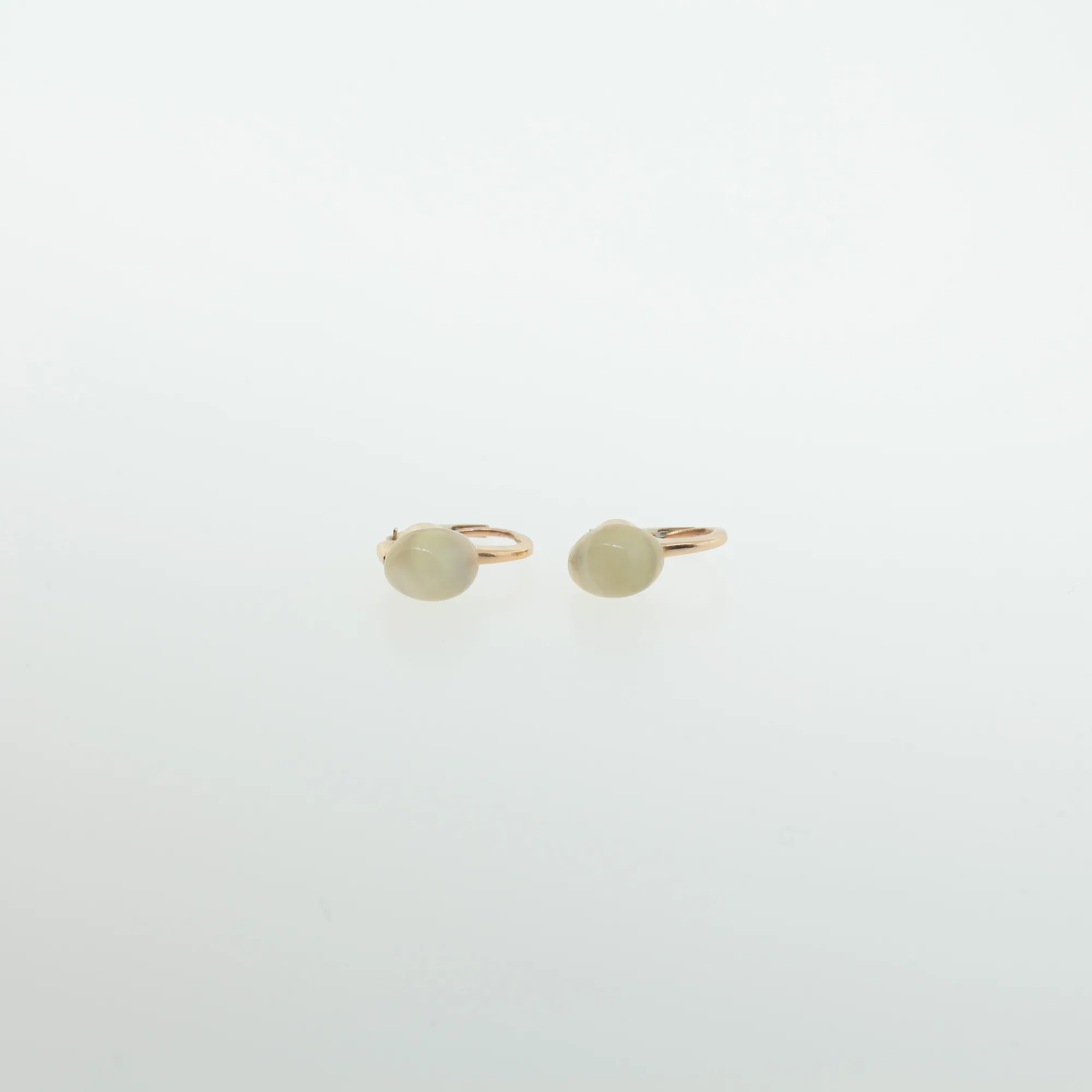 Close-up angled view of earring hinges showing two-tone metal construction