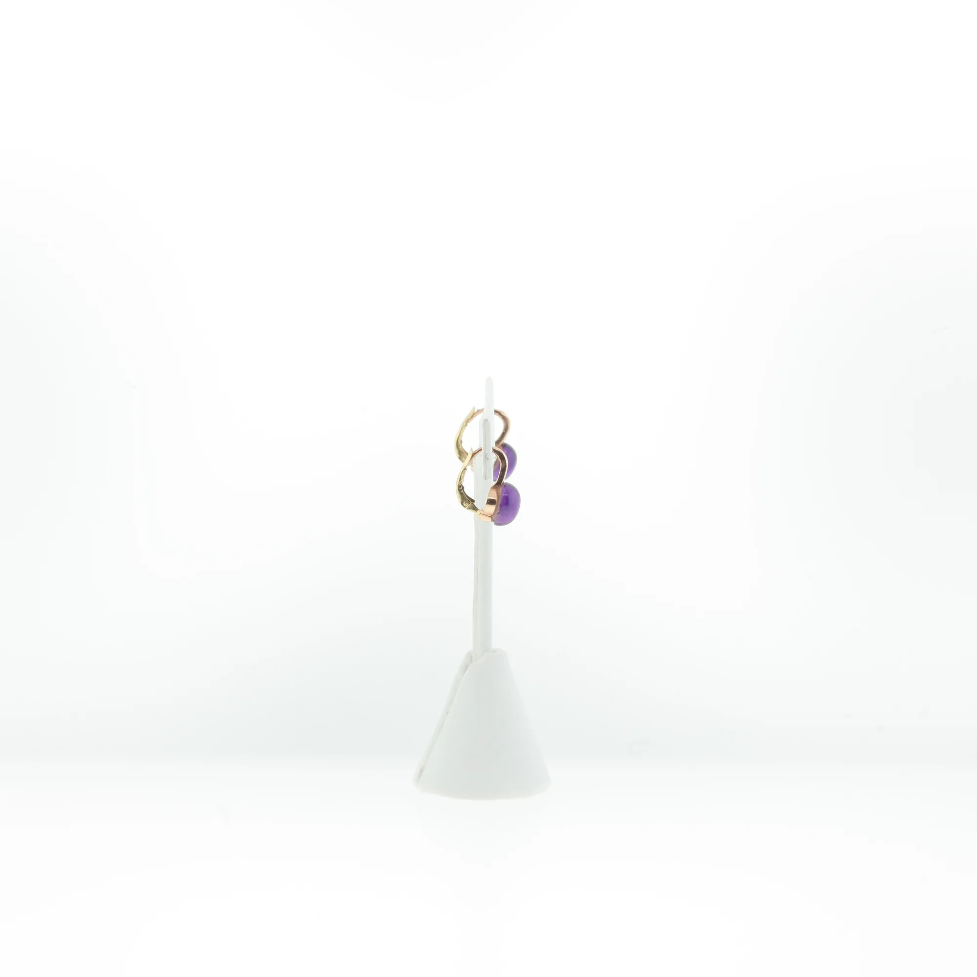 Side view showing the lever-back closure mechanism of the drop earrings on a display stand
