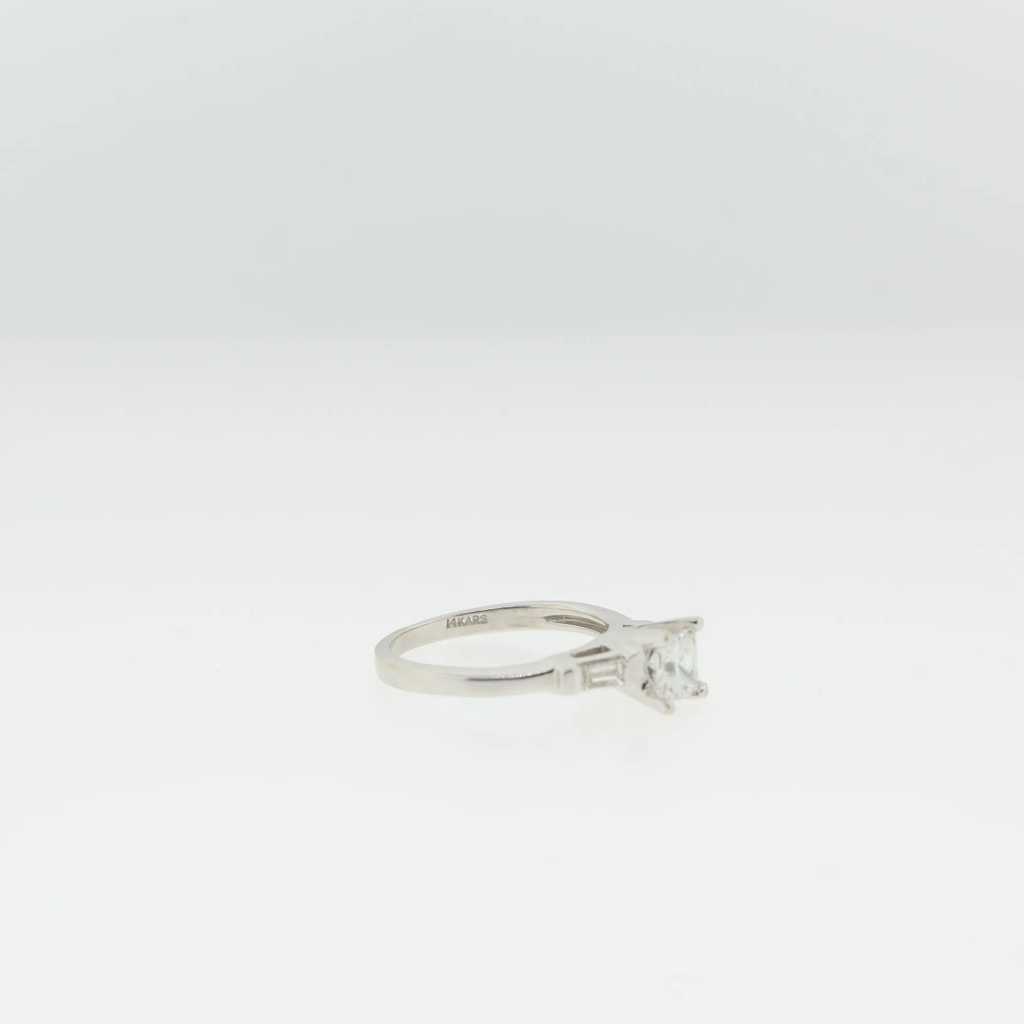 Side view of the ring with the interior hallmark reading 14KARS visible on the band