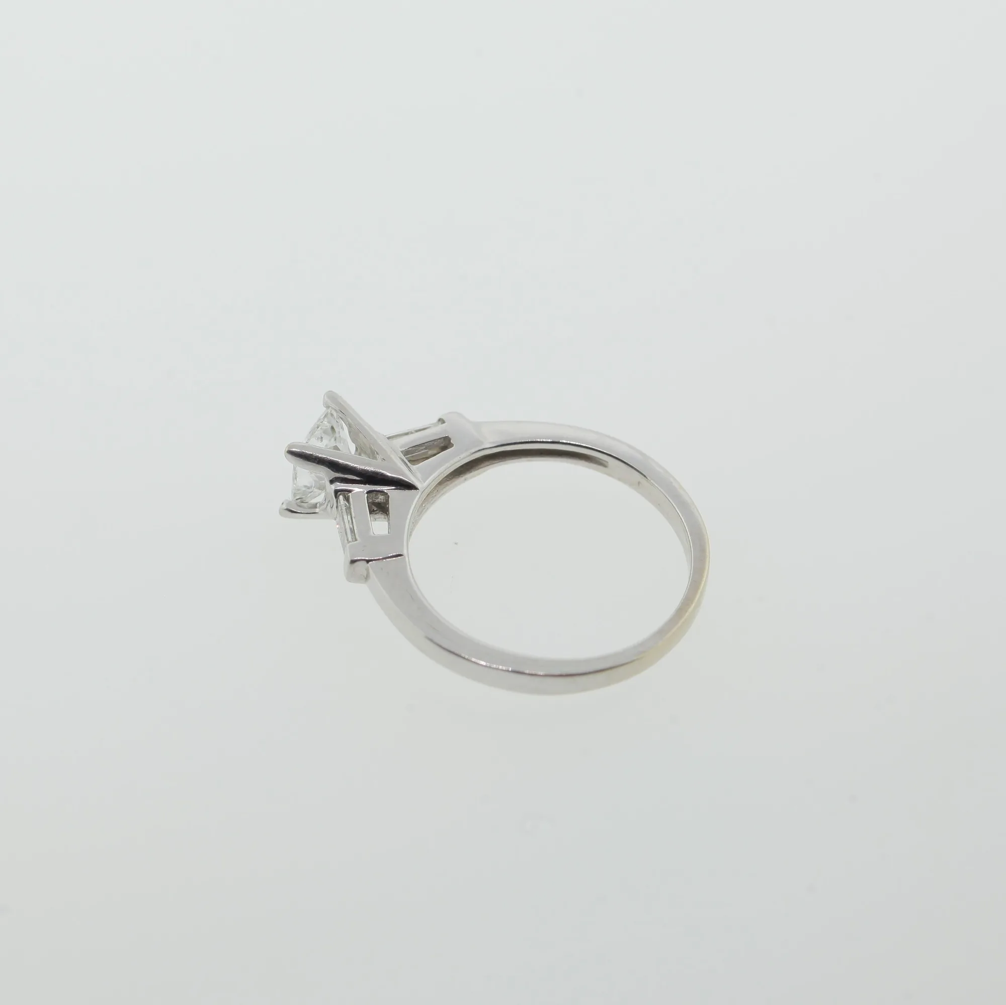 Side profile of the ring lying down, showing the open gallery and prong setting from above