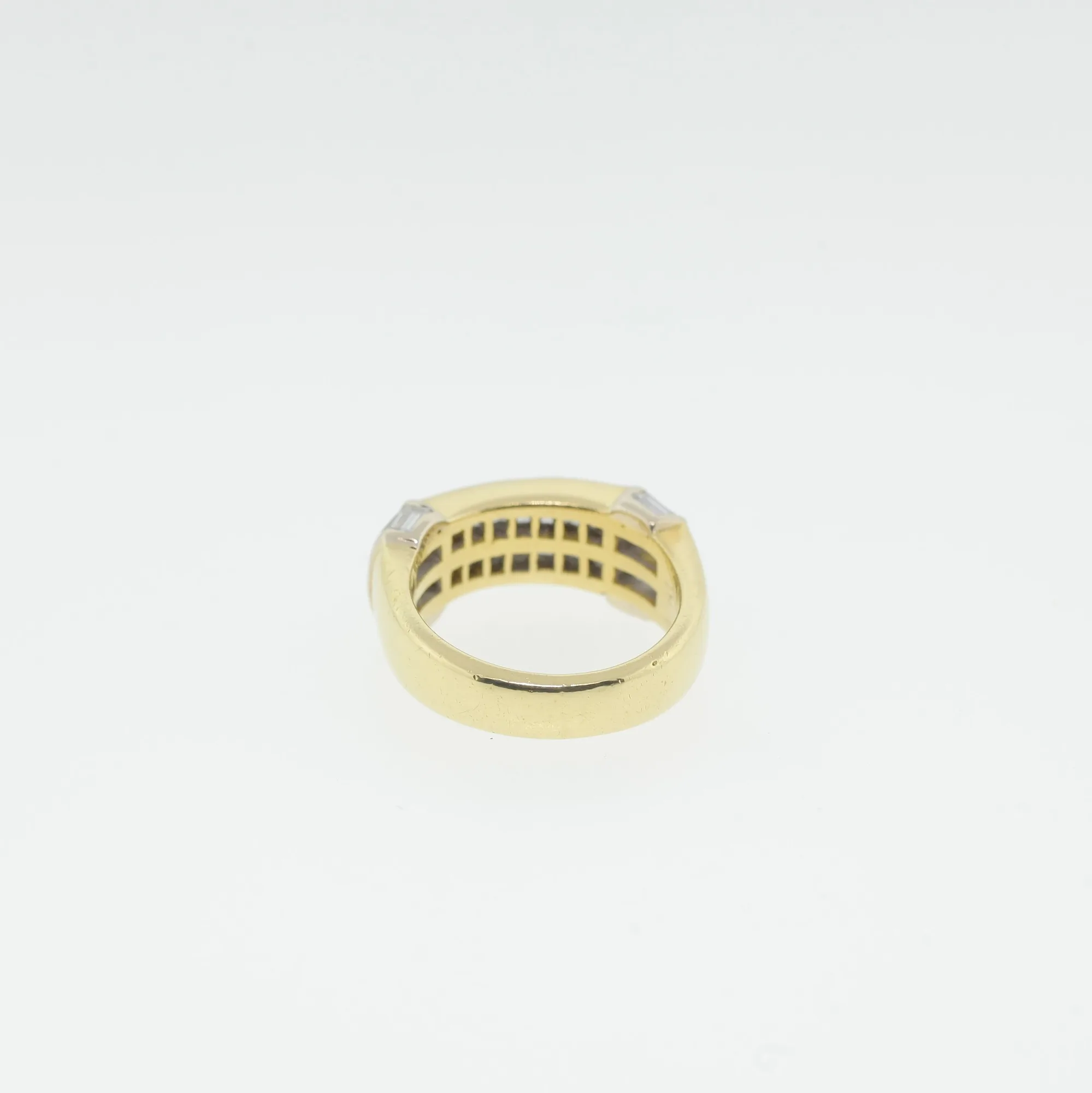 Interior back view of the ring showing the polished yellow gold band and open gallery framework