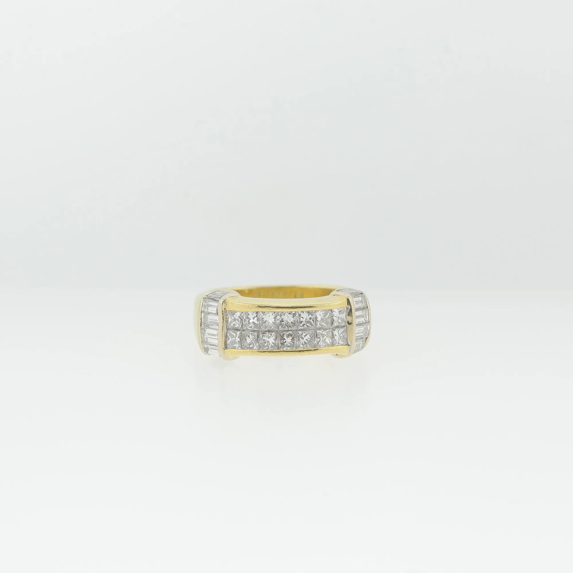 Front view of an 18K yellow gold ring with channel-set princess-cut stones in a two-tone setting
