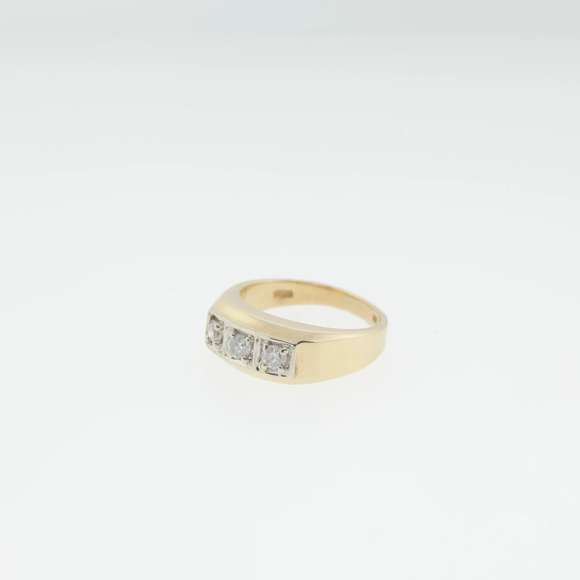 Side view of the gold band showing the raised white metal setting and stones