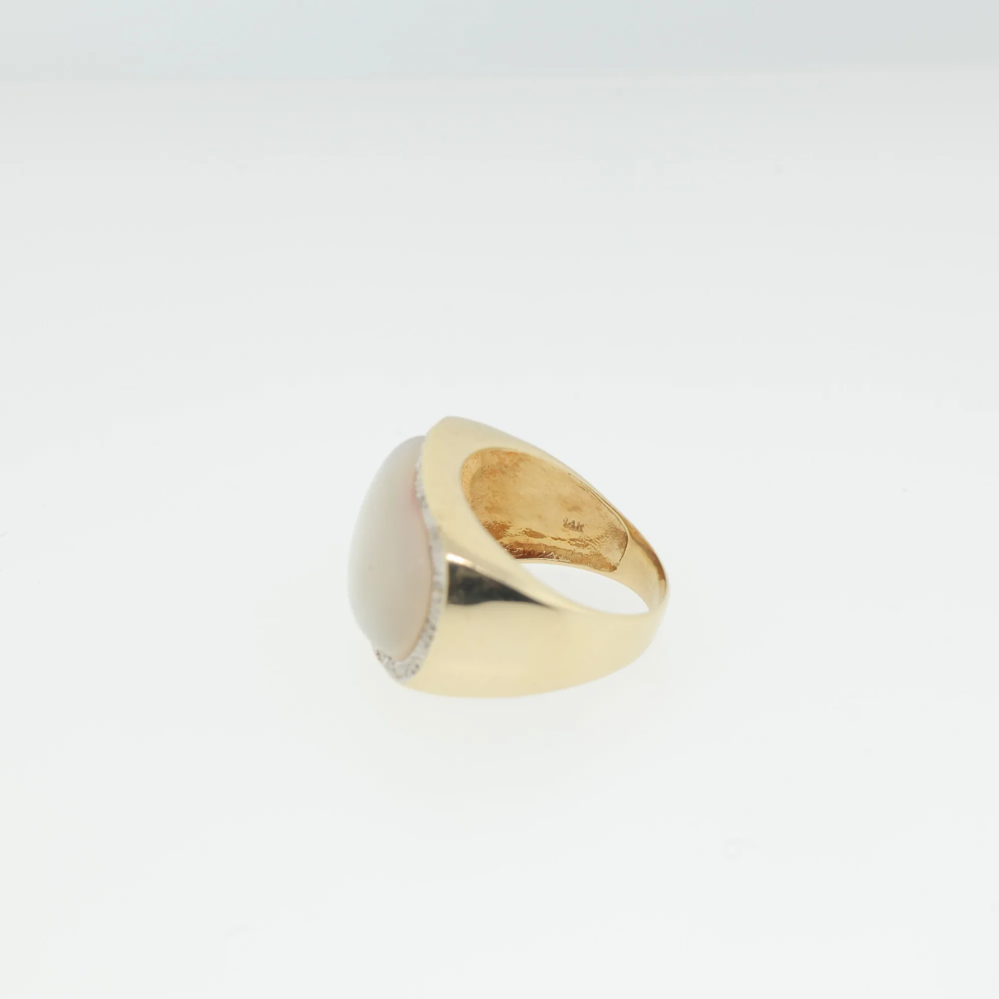 Side view of the ring showing the gold shank and stamped 14k mark inside the band