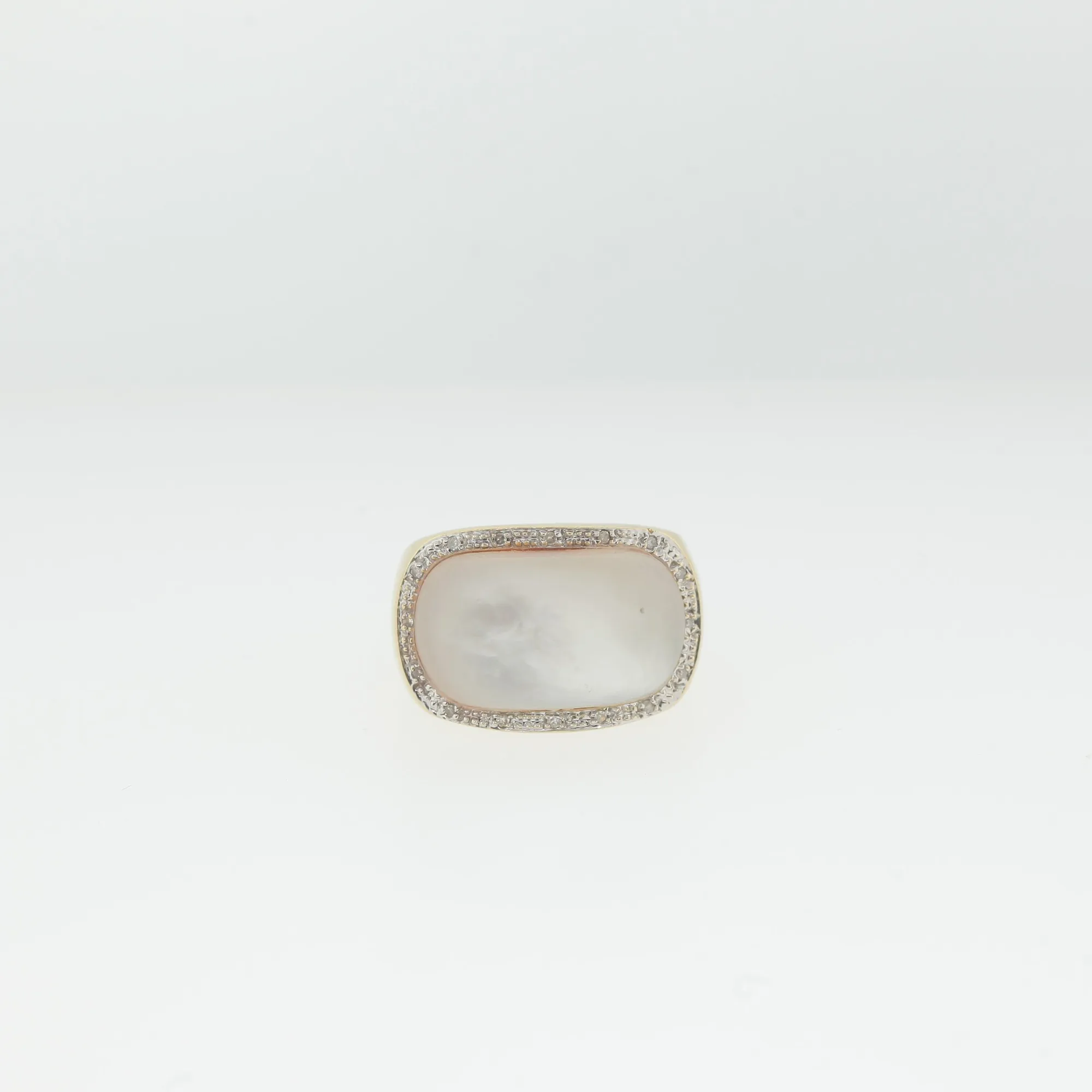 Top-down view of the ring showing the full cabochon stone and surrounding pavé border