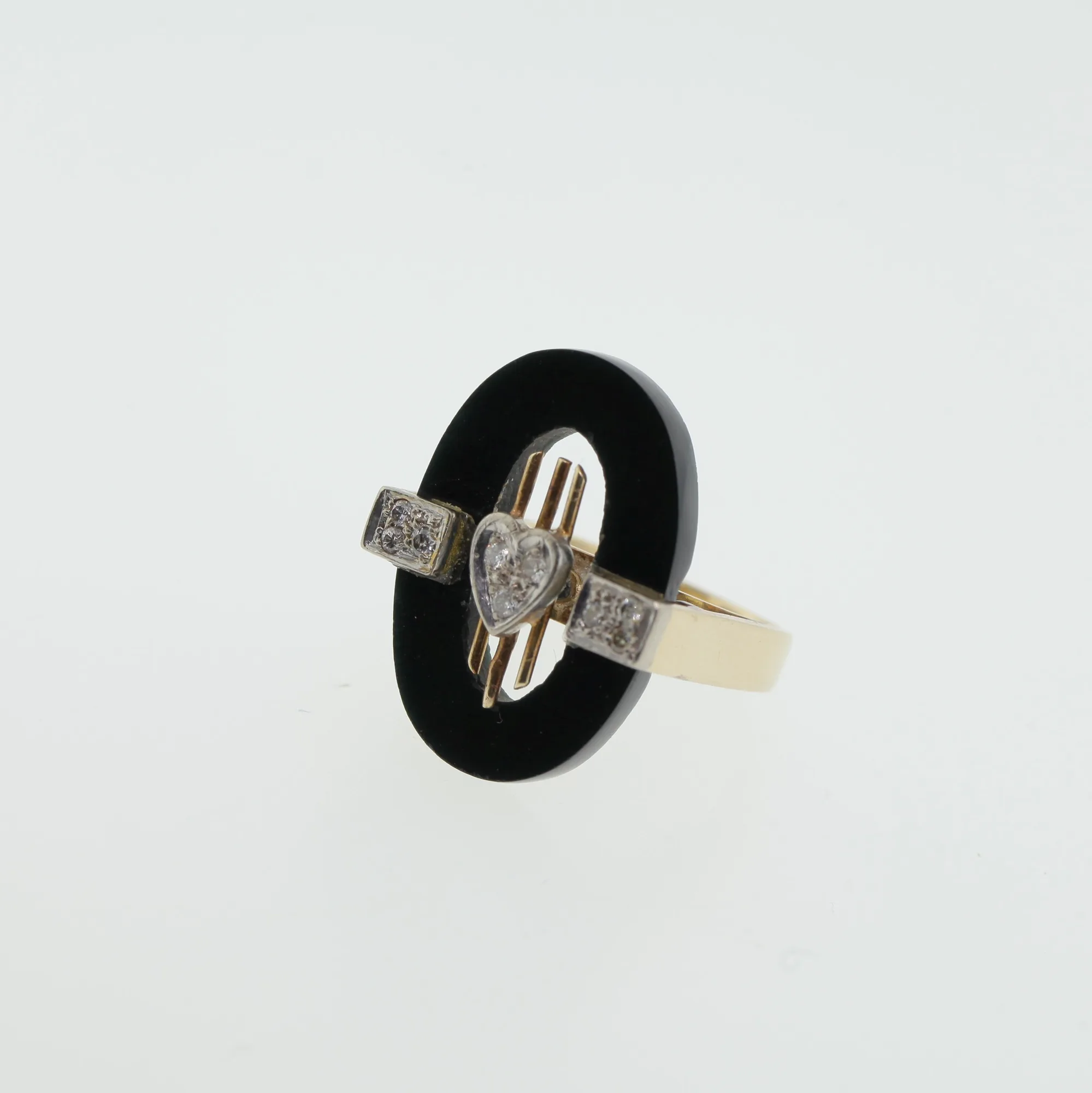 Angled top view of the ring showing the heart motif and pavé-set rectangular panels