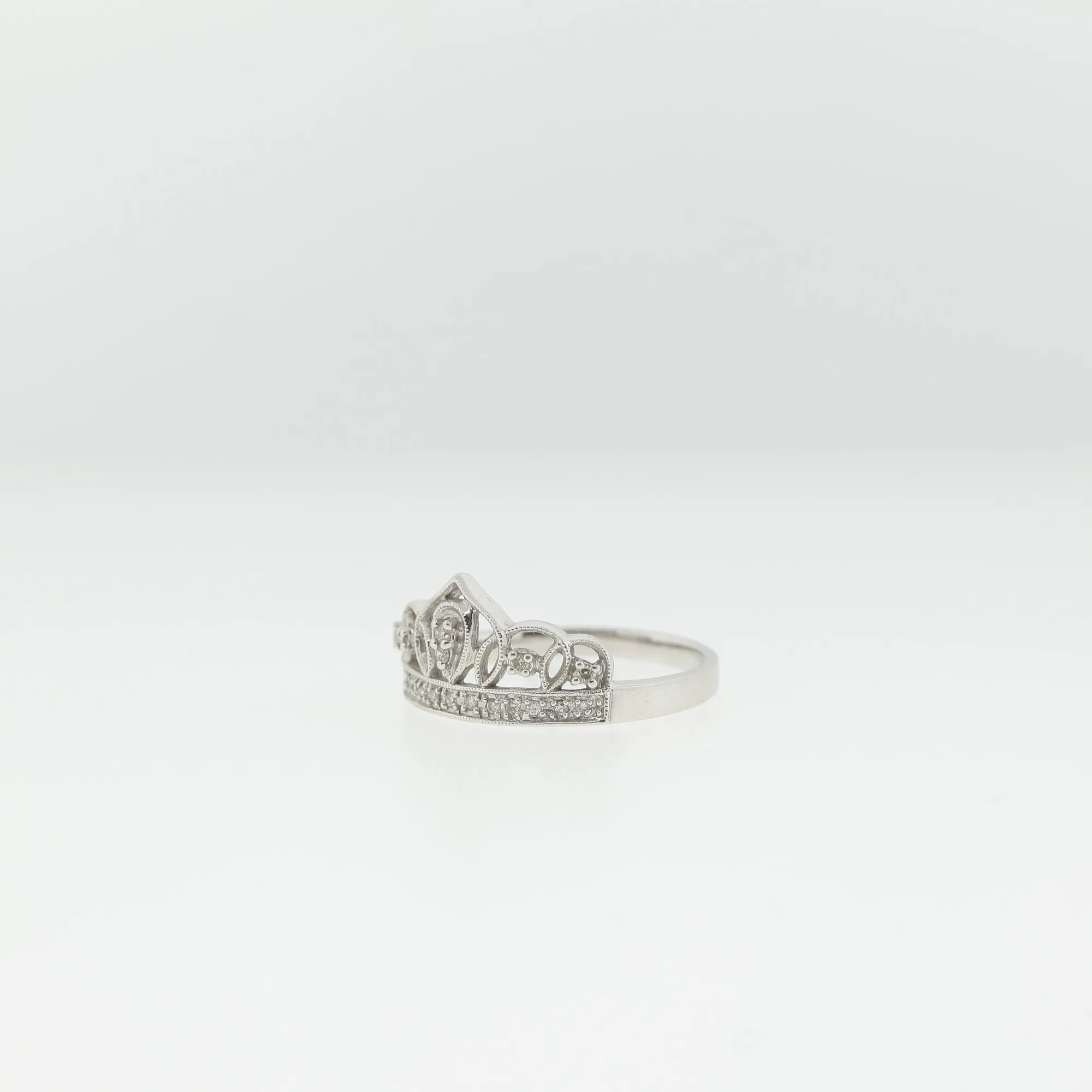 Side angle of the crown ring showing the tapered shank and pierced detailing