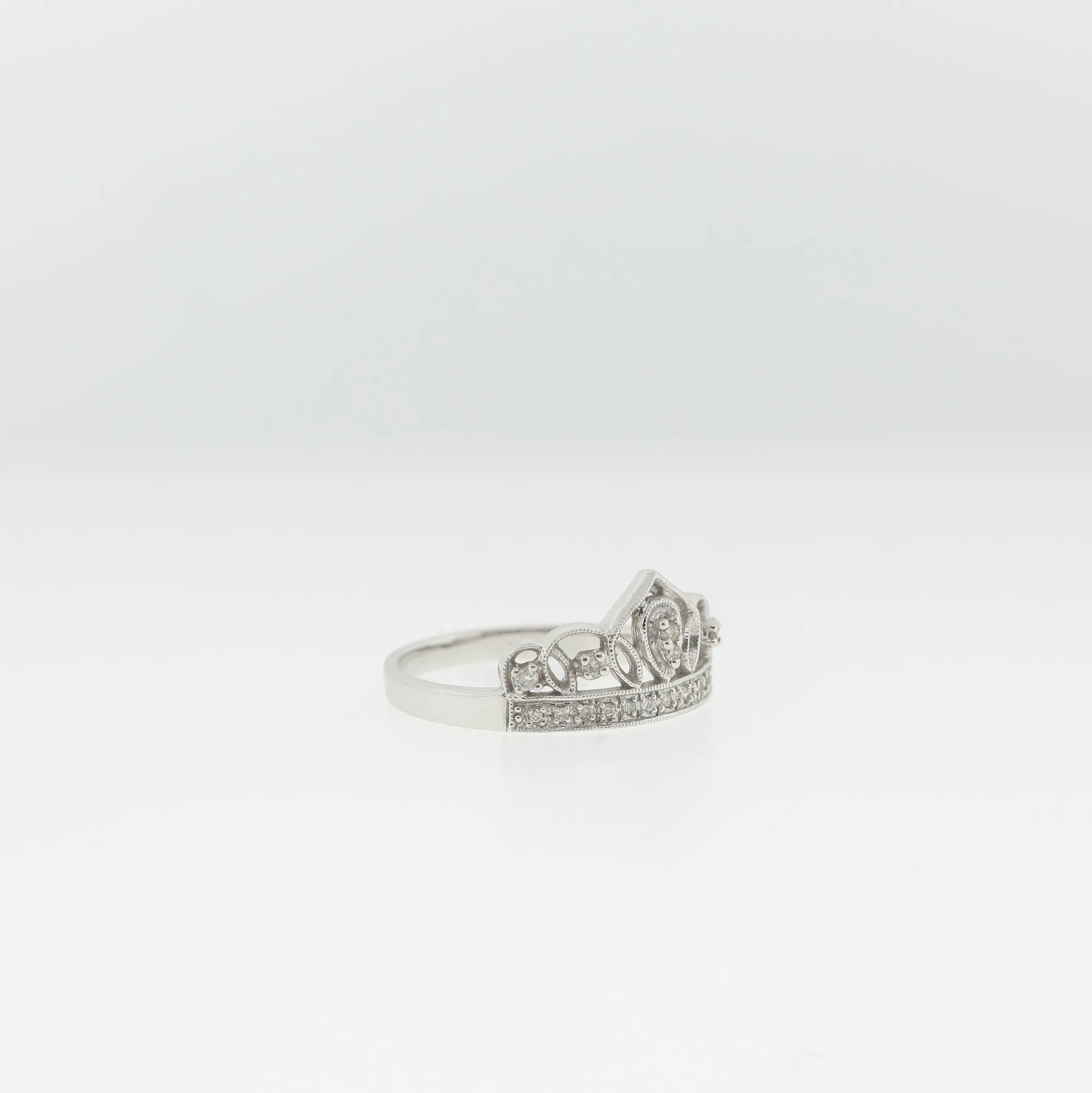 Angled side view of the crown ring showing the openwork gallery beneath the stones