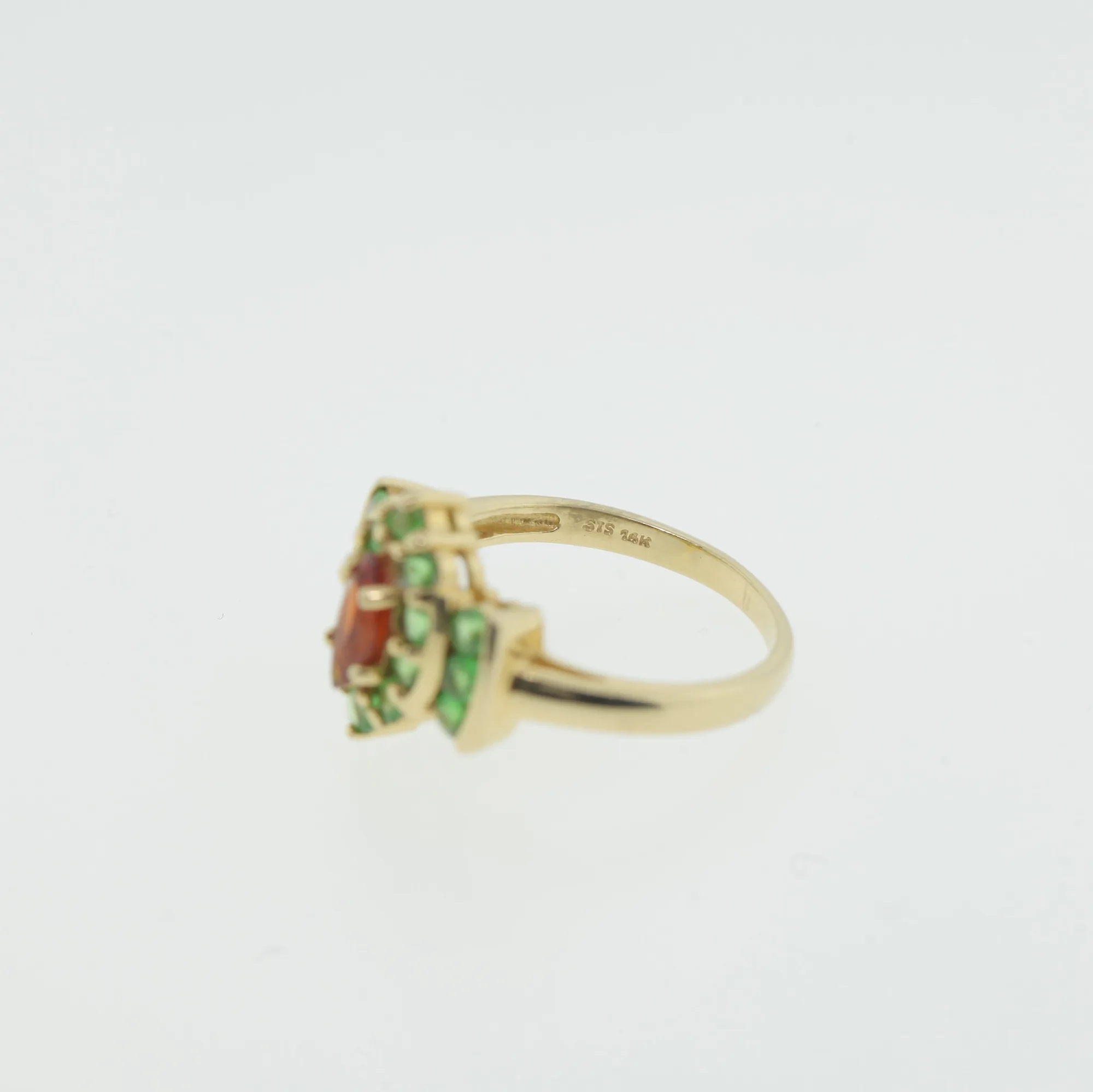Close angled view of the ring's shank and gemstone cluster construction
