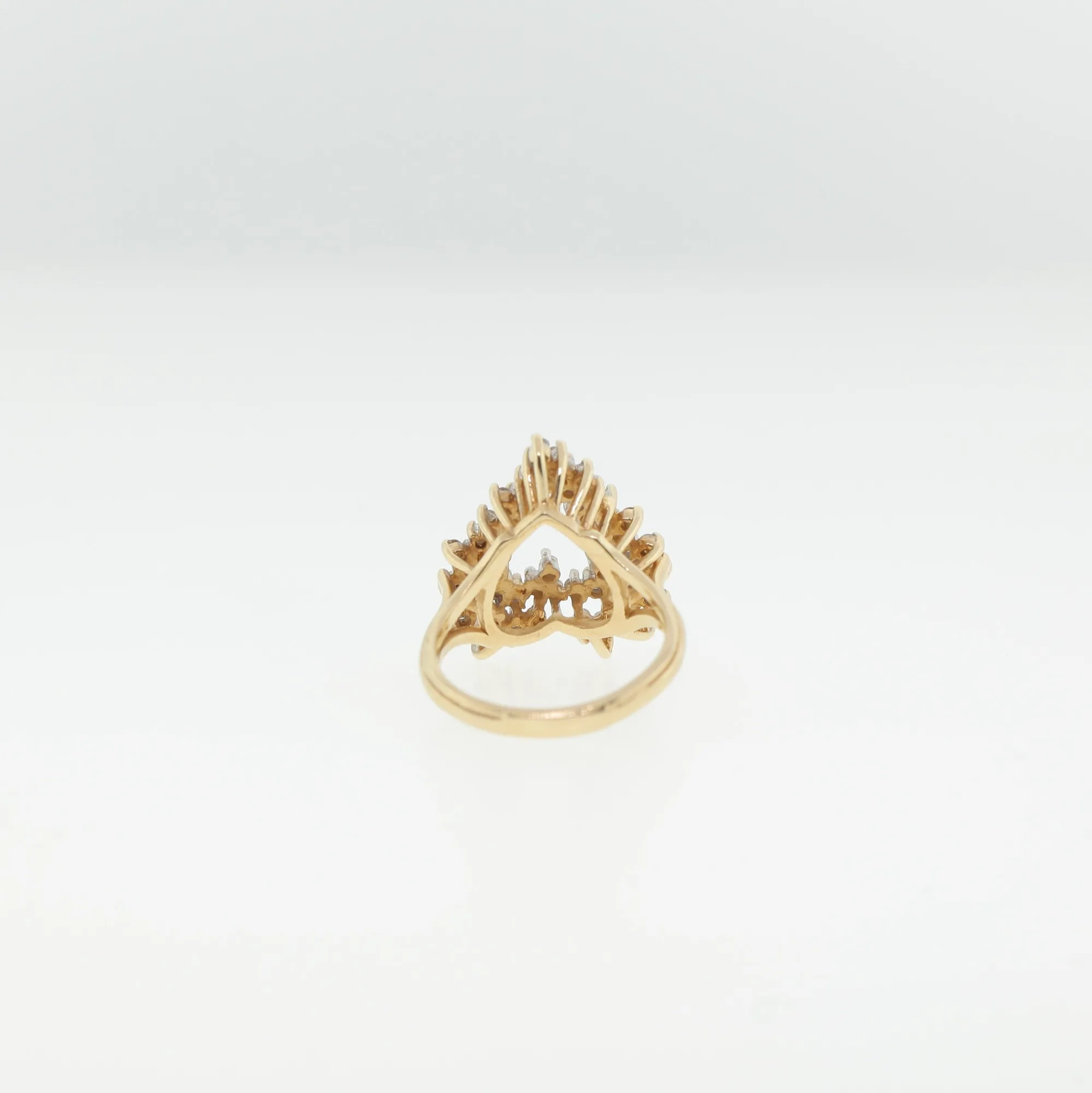 Back view of the ring showing open gallery work and prong settings beneath the heart-shaped cluster
