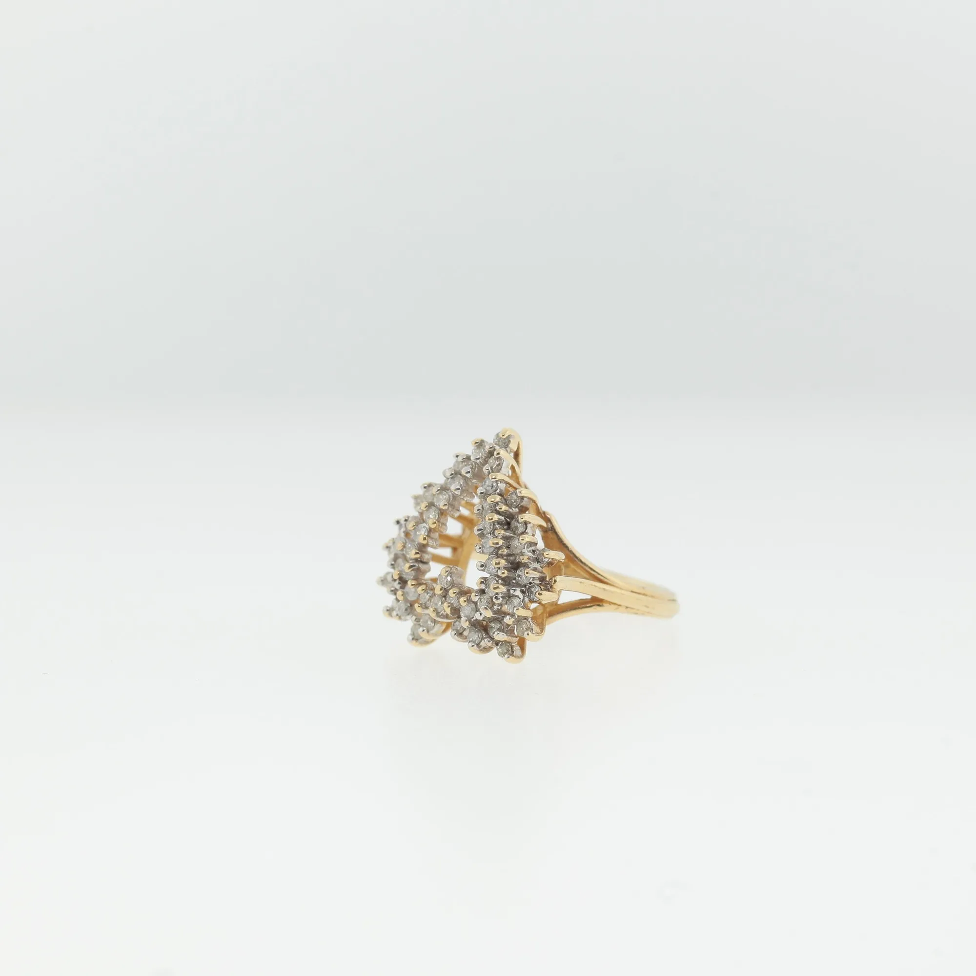 Side profile of the ring showing the raised, dimensional height of the stone cluster