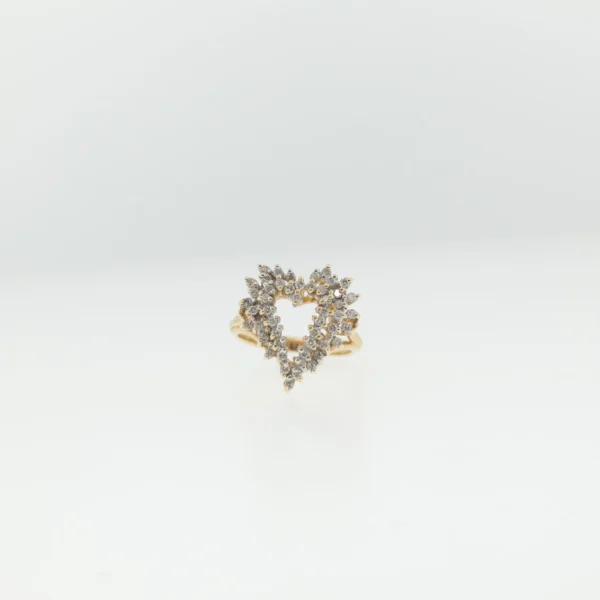 Front view of heart-shaped cluster ring with rows of small faceted clear stones on a gold-tone band
