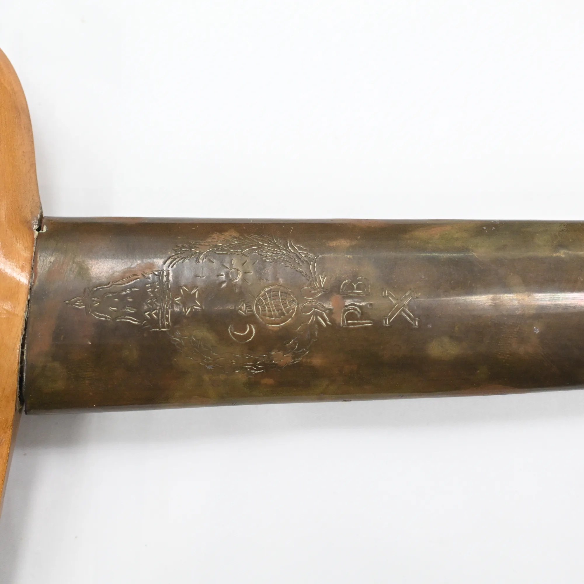 Close view of the engraved crest with crescent, star and P B initials on the sheath