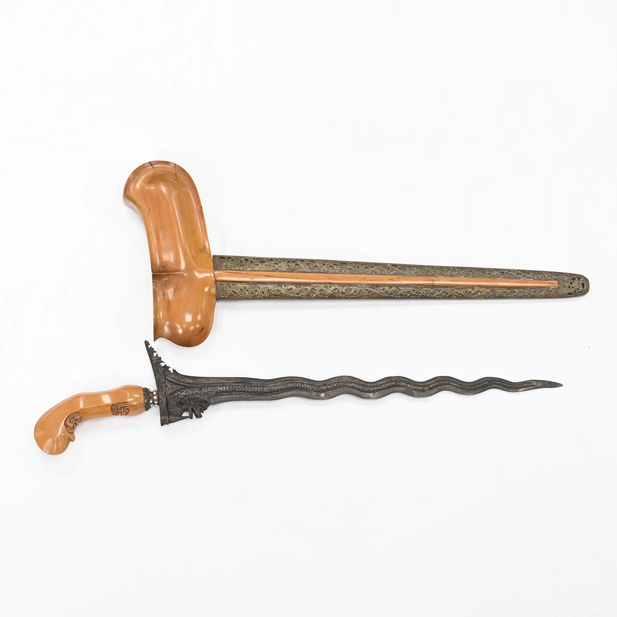 Keris dagger and sheath side by side showing the wavy blade