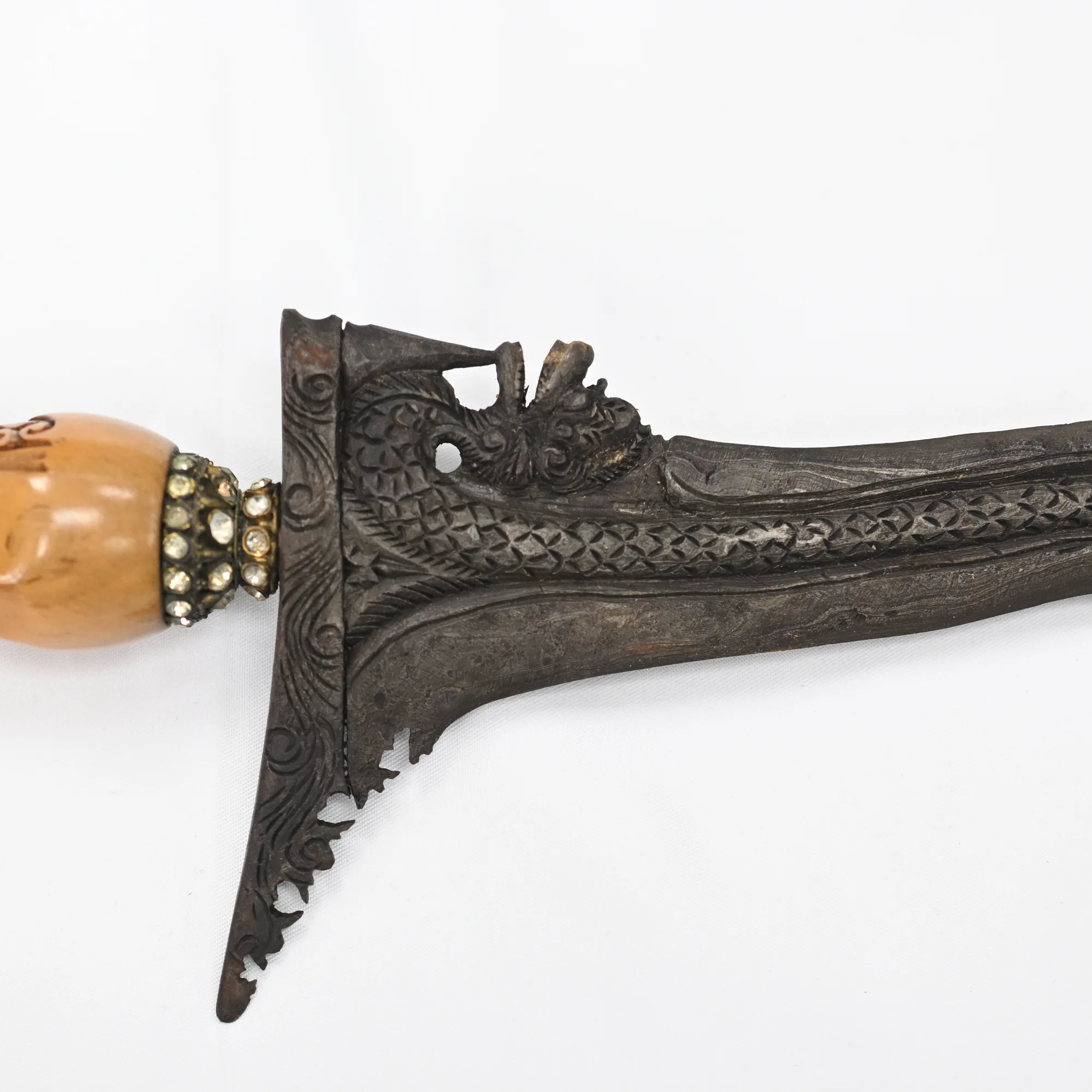 Close view of the carved guard and jeweled collar