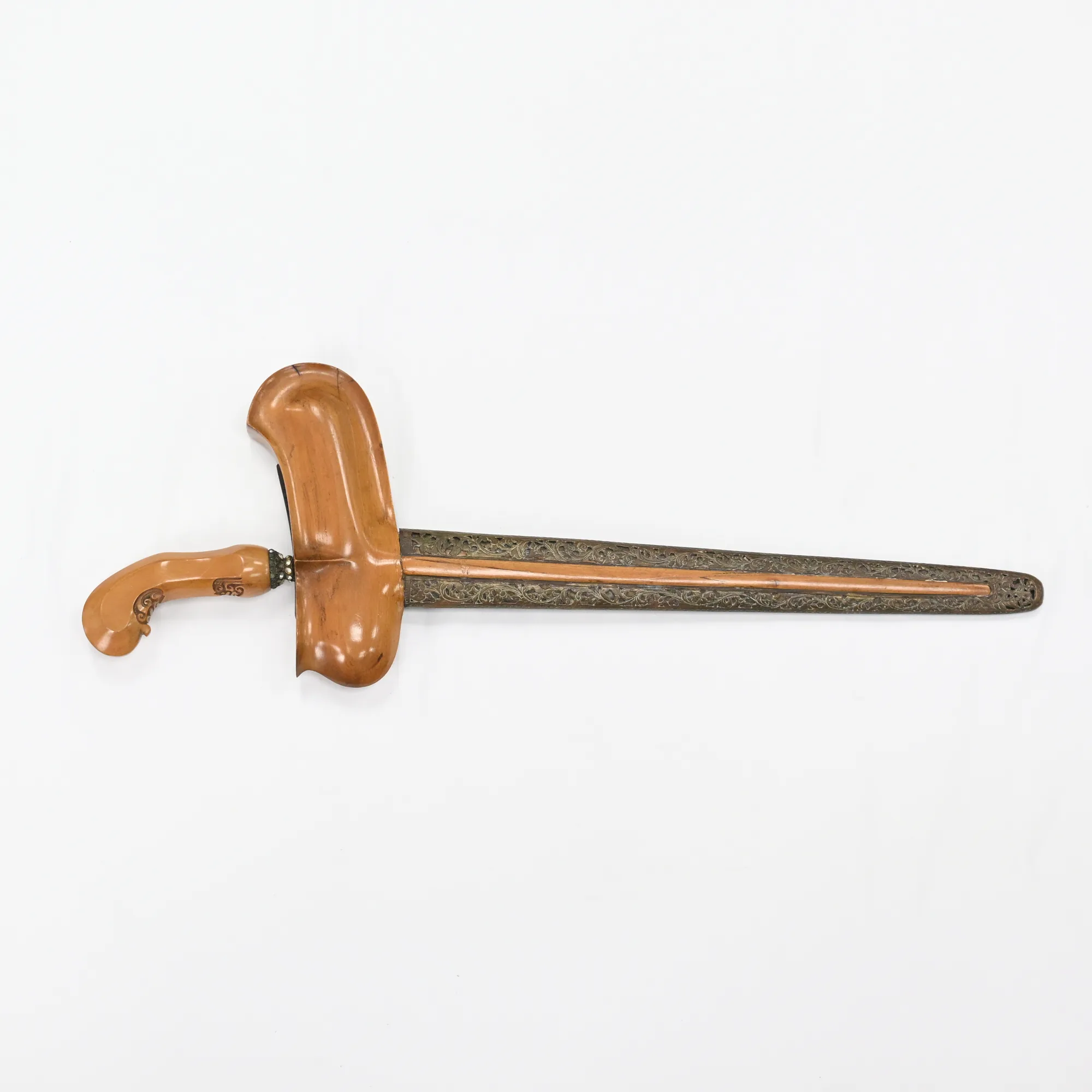 Keris dagger in its sheath with carved wood hilt and boat-shaped sheath top